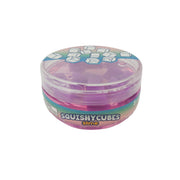The Toysmith Squishy Cube Slime by Toysmith is a round plastic container with a rainbow label, filled with translucent purple slime and squishy cubes inside. The lid shows smiling cube illustrations.