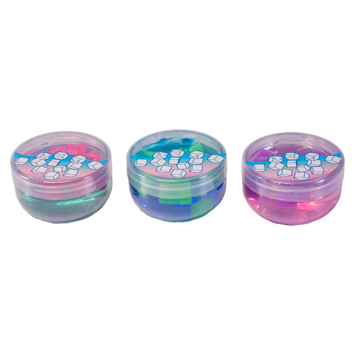 Three small round Toysmith Squishy Cube Slime containers in pink, blue, and purple are displayed side by side. Each has a clear lid with an ice cube illustration, showcasing the colorful, translucent sensory slime inside.