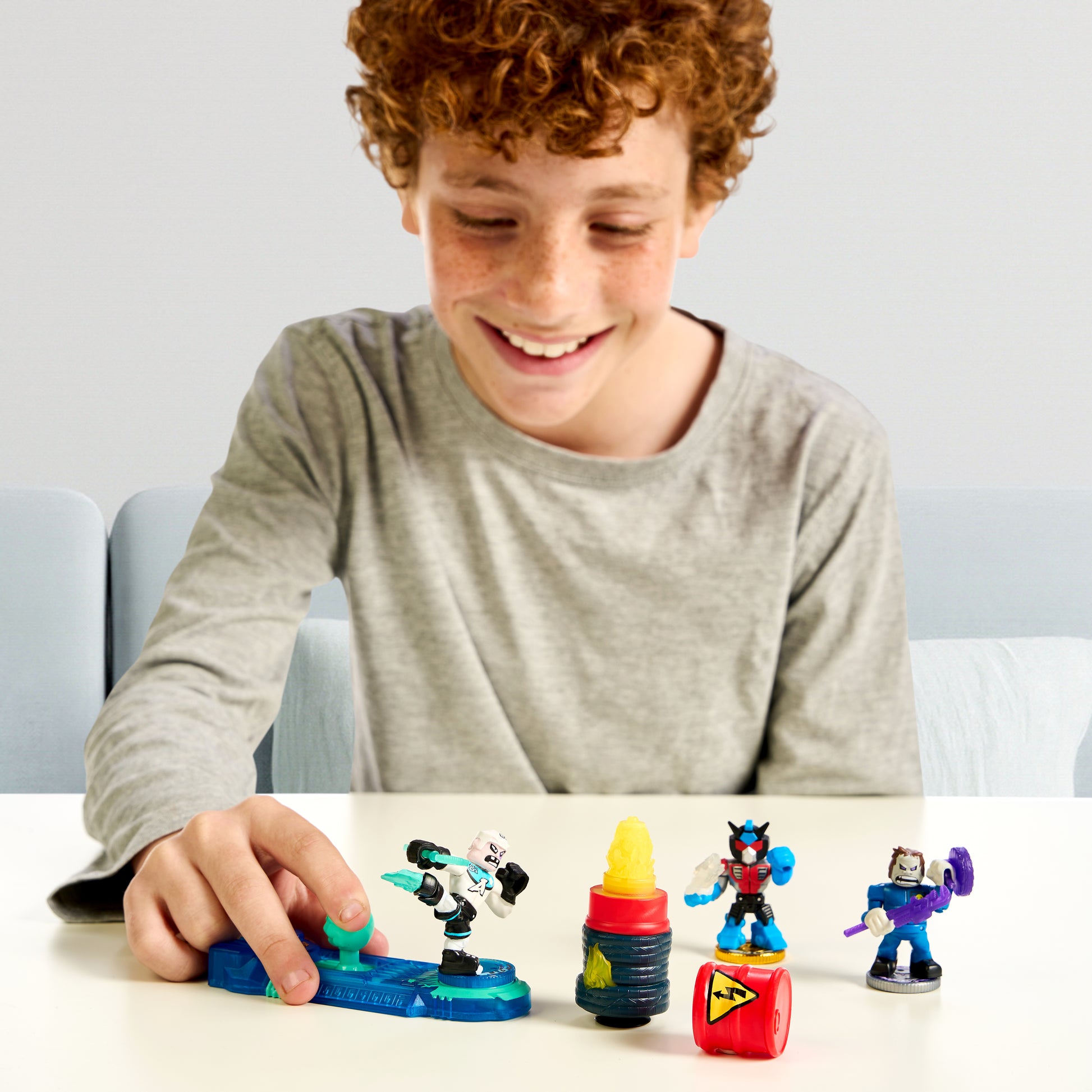 Child playing with toy figures on a table
