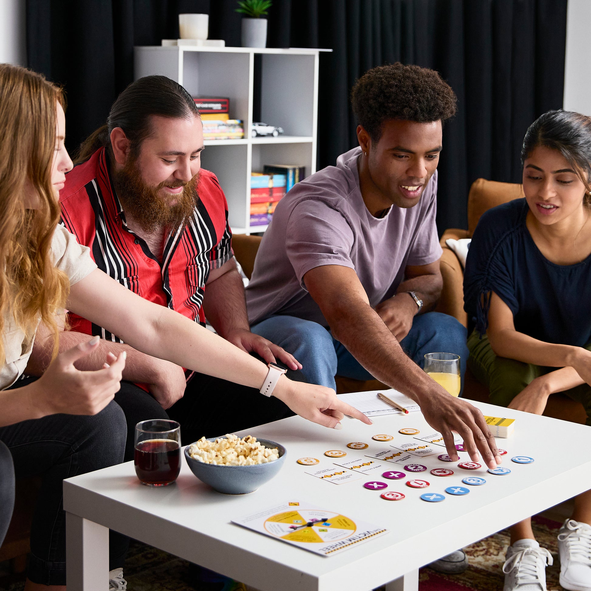 Group of friends playing a board game together in a cozy living room.