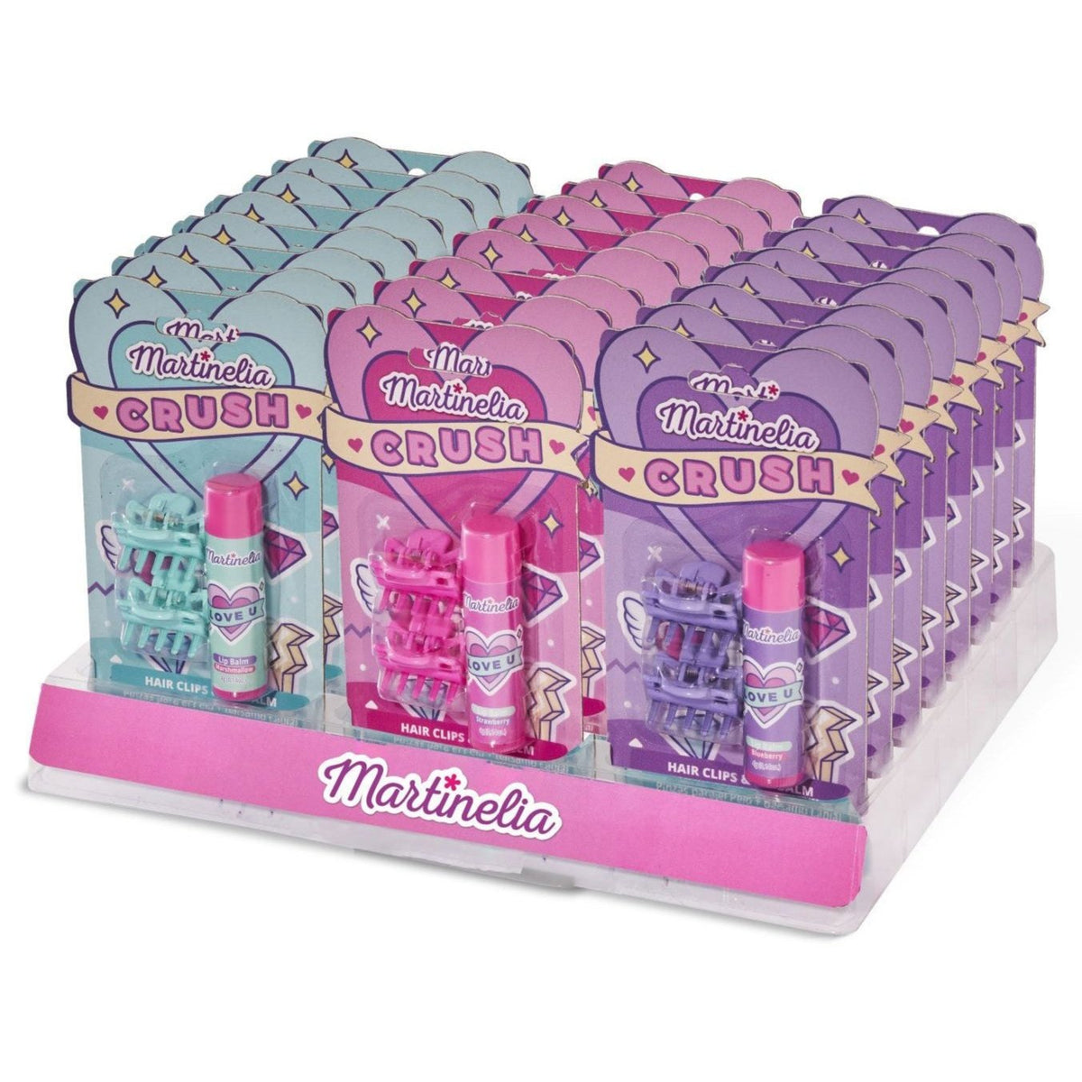 A display of Martinelia Crush Hair Clips & Lip Balm gift sets by Martinelia, featuring vibrant hair clips and lip balm in pastel boxes, organized neatly on a pink and white stand.
