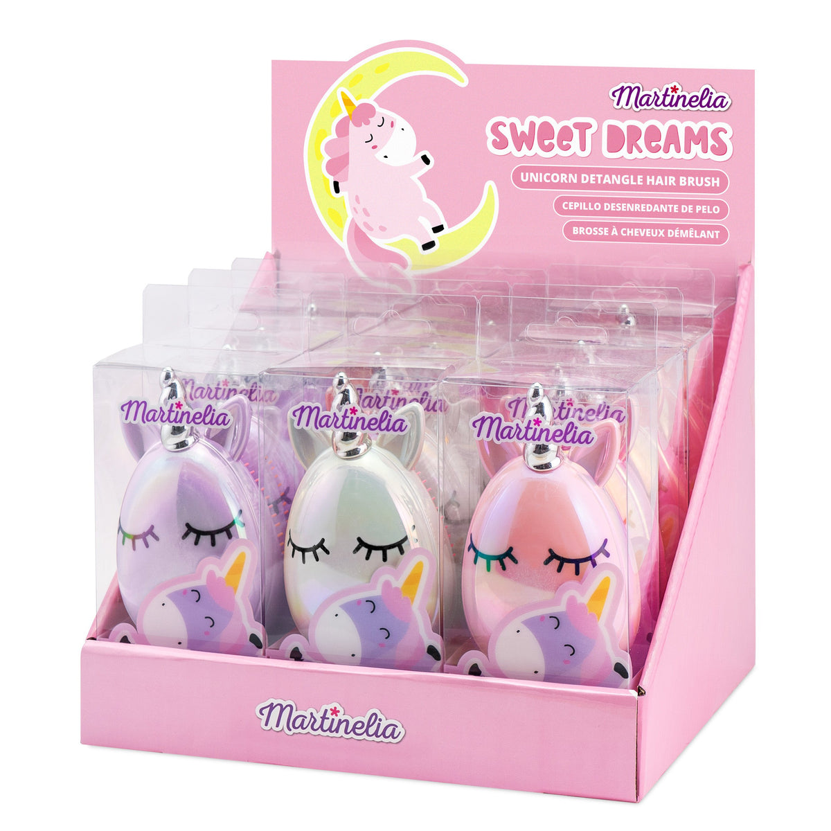 A pink Martinelia display box labeled "Sweet Dreams" holds pastel-colored Unicorn Detangler Hair Brushes, each with a sleeping unicorn face. The box features a cartoon unicorn and crescent moon—perfect as a kids' hair brush.