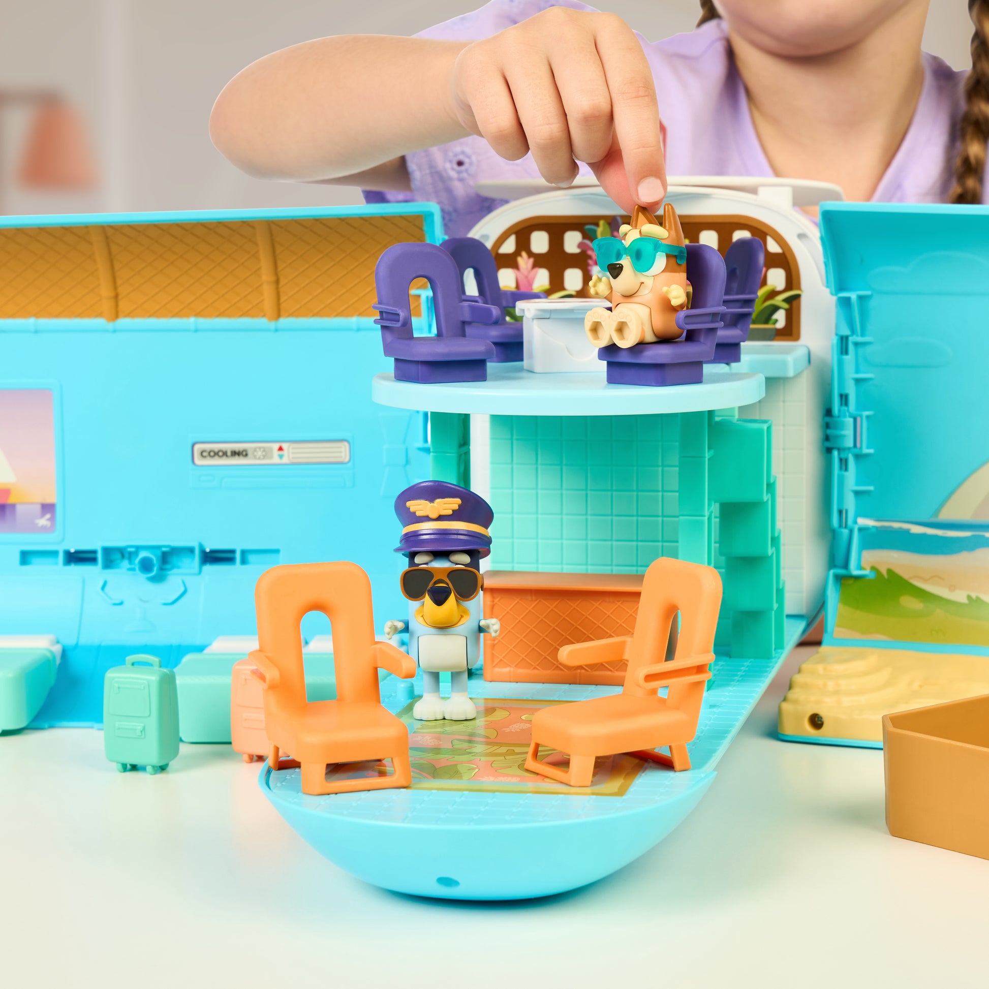 Child playing with a toy airplane set on a table