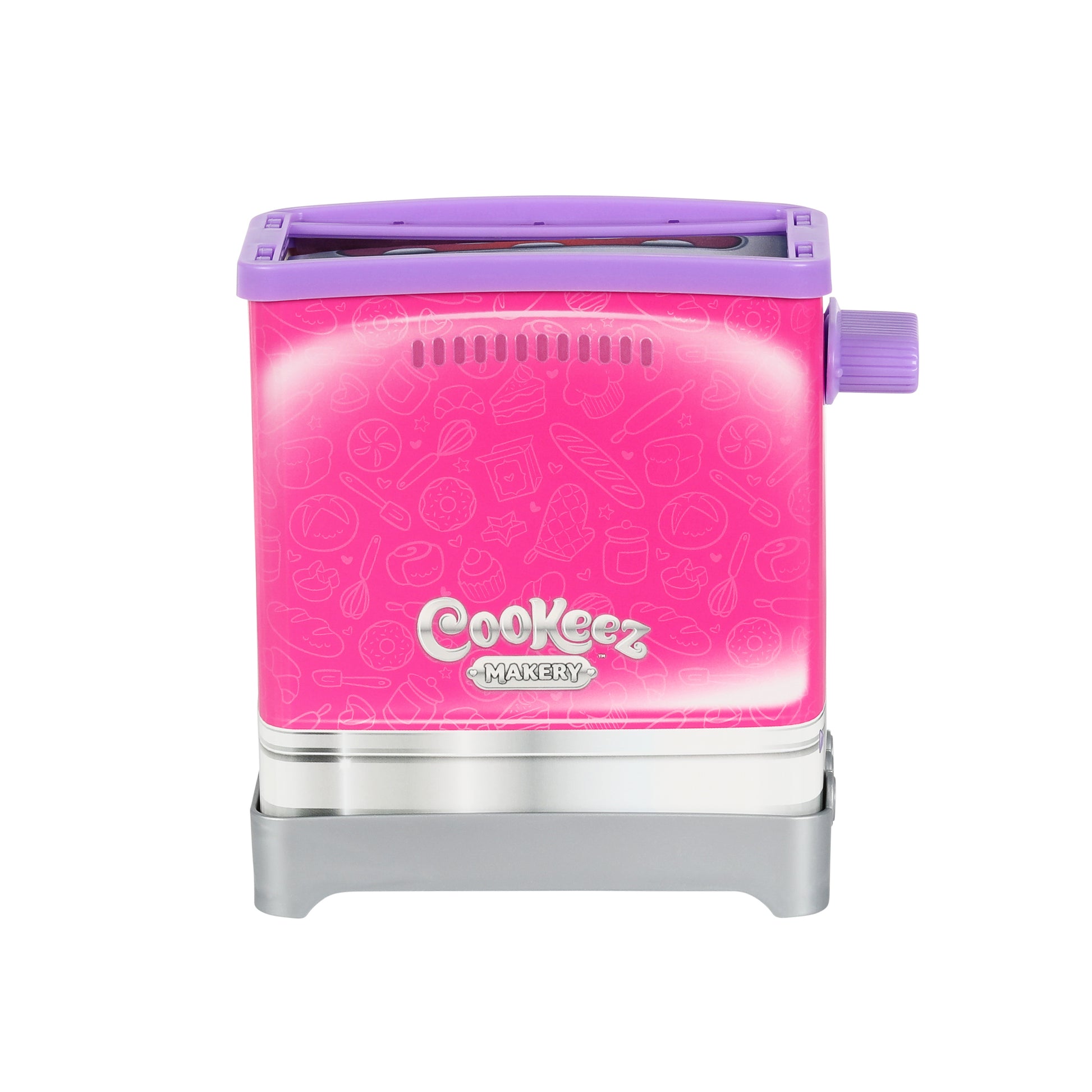 A pink and purple Cookeez Makery Toasty Treatz toy toaster with playful food graphics, silver base, and a purple side lever is shown against a white background.