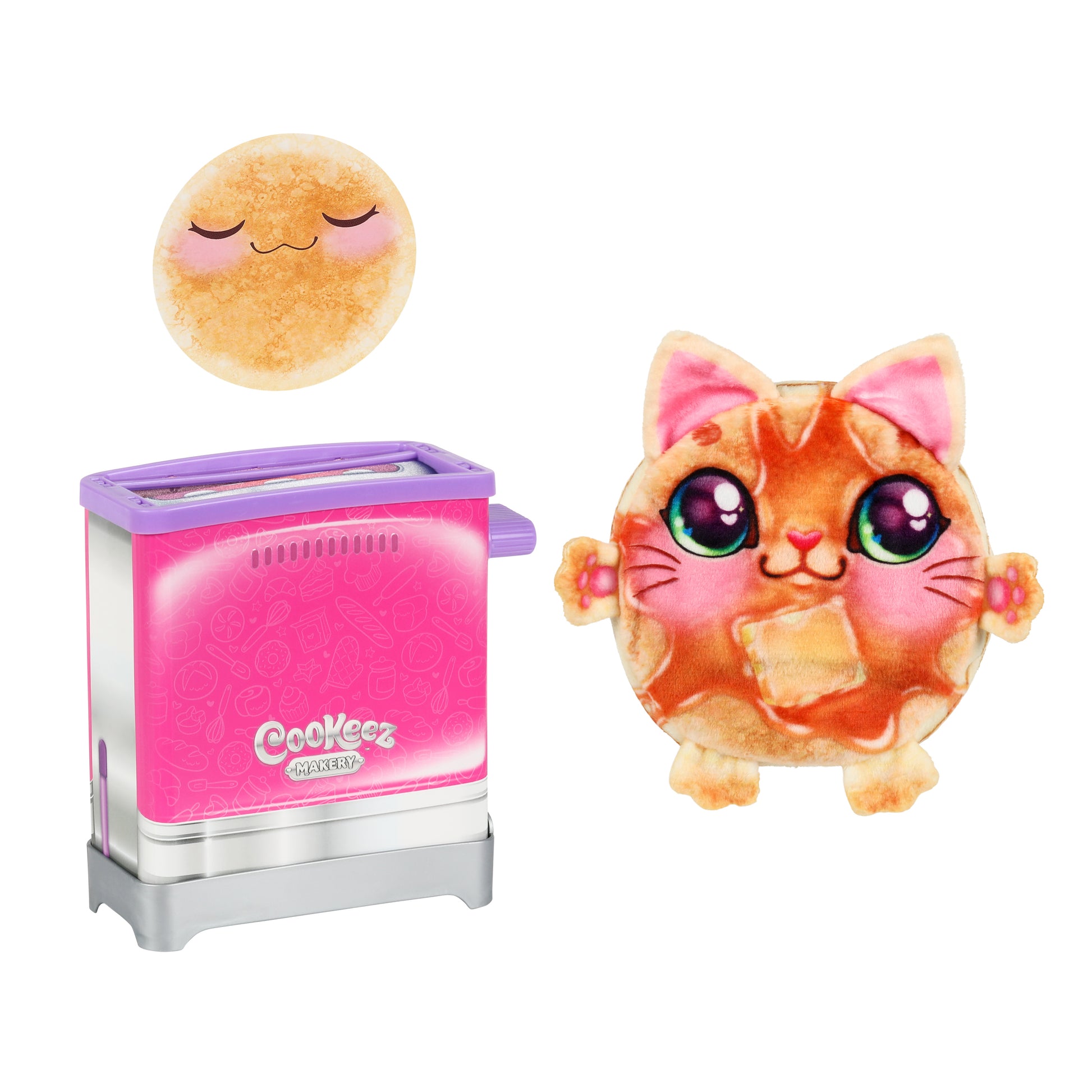 A round Cookeez Makery Toasty Treatz plush pancake with a cute cat face and big eyes stands by a pink and silver toy toaster, while above them is another plush pancake with closed eyes and a peaceful look.