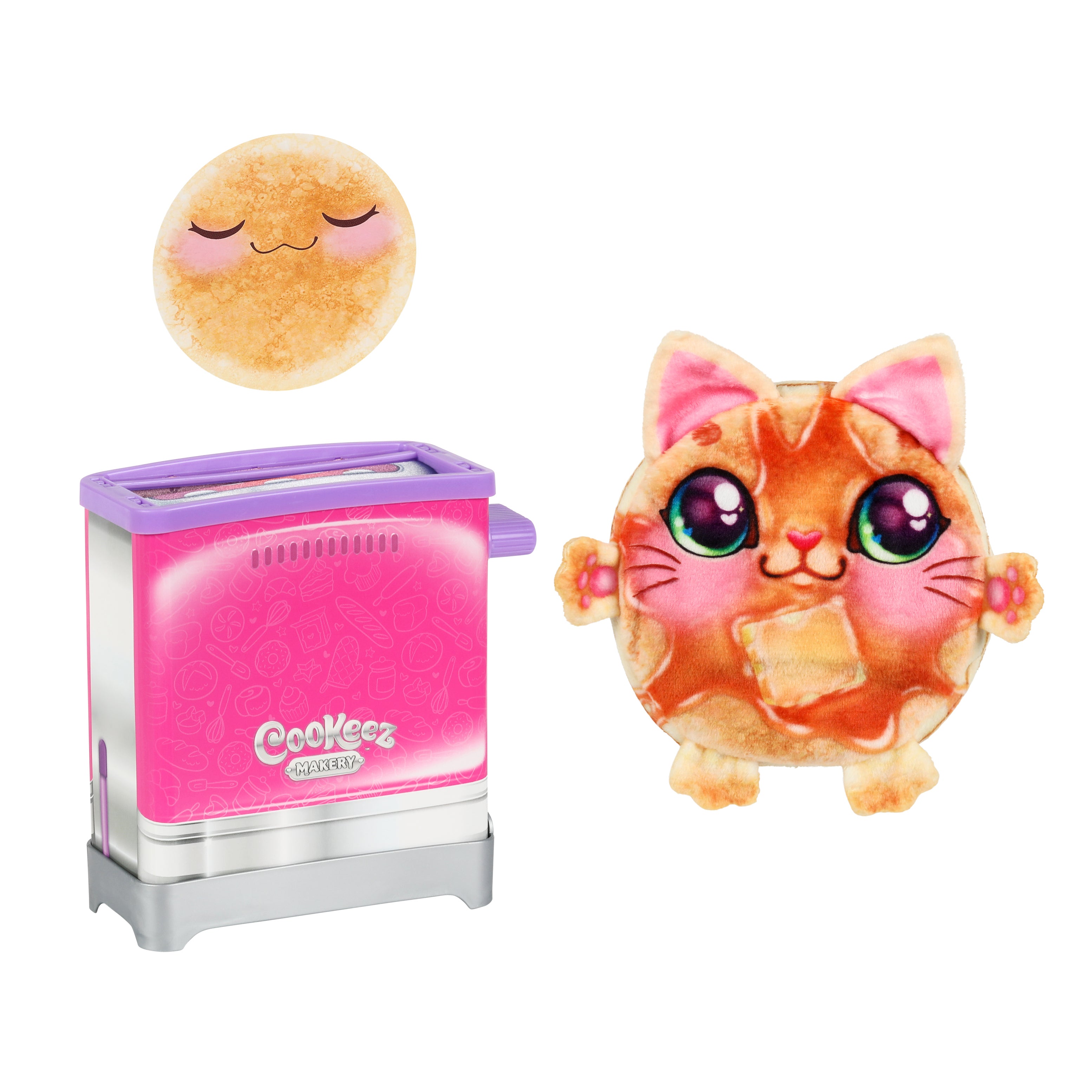 A round Cookeez Makery Toasty Treatz plush pancake with a cute cat face and big eyes stands by a pink and silver toy toaster, while above them is another plush pancake with closed eyes and a peaceful look.