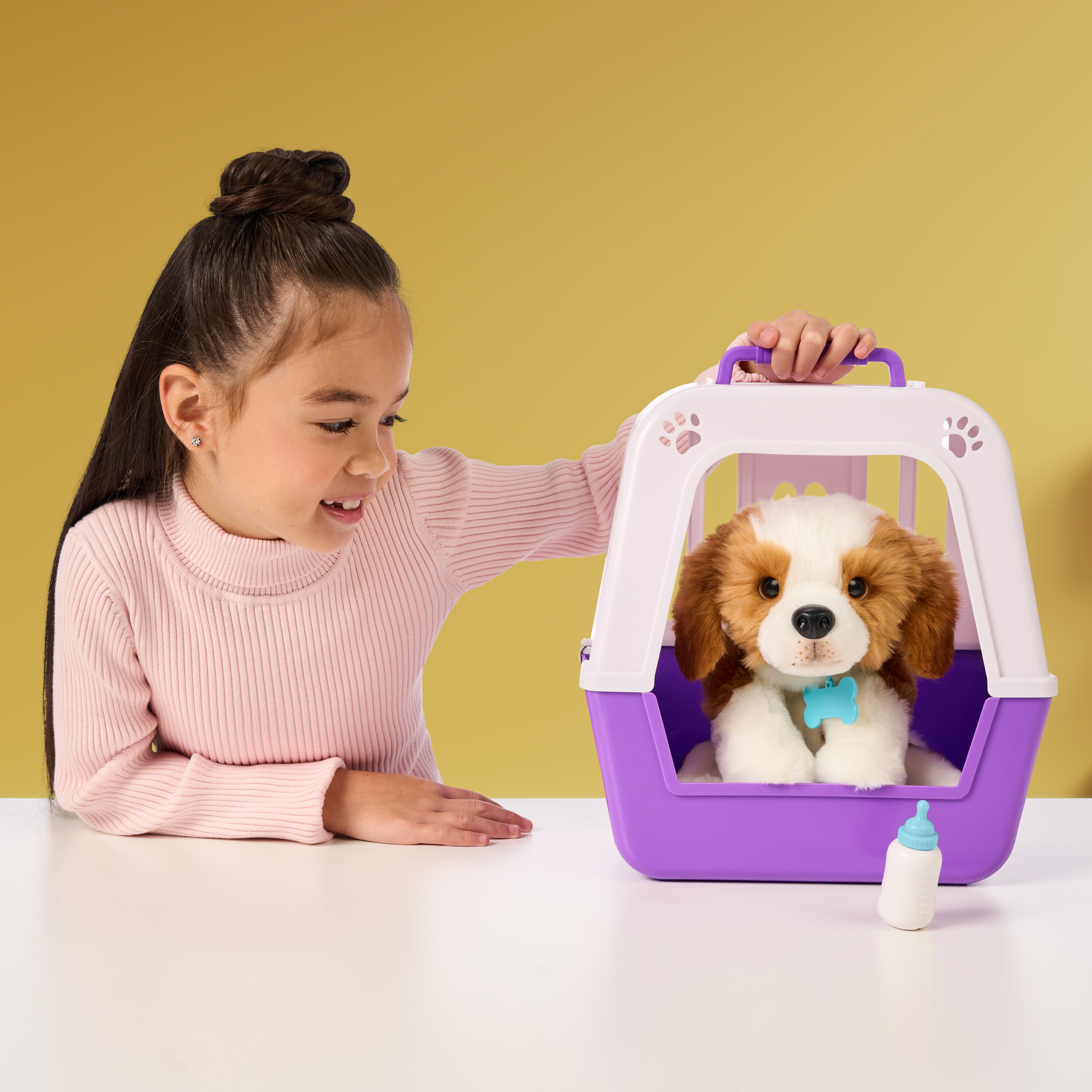 Child with a toy pet carrier featuring a plush dog inside on a yellow background