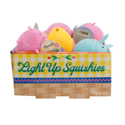The Toysmith Light-Up Squishies box by Toysmith includes colorful, spiky, animal-shaped squishy toys in pink, yellow, blue, and purple—perfect for sensory play with their basket weave and yellow checkered design.