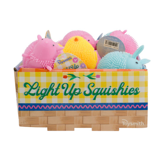The Toysmith Light-Up Squishies box by Toysmith includes colorful, spiky, animal-shaped squishy toys in pink, yellow, blue, and purple—perfect for sensory play with their basket weave and yellow checkered design.