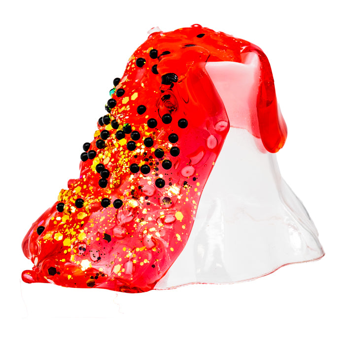The Toysmith Crispy Crunch Lava Slime by Toysmith features a clear plastic volcano model that erupts with bright red slime filled with black and yellow beads to mimic lava and volcanic debris, all set against a white background.