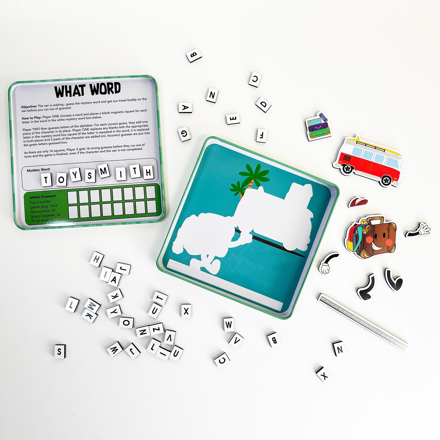 On the Way Games Magnetic What Word is a travel set in a metal box with letter tiles, wipeable marker, and illustrated magnetic pieces like a van and tropical scene. Instructions are visible inside the lid for educational fun on-the-go.