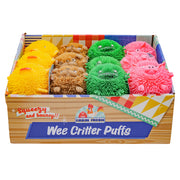 A Farm Fresh Wee Critter Puffs display box features squeezable, spiky animal sensory toys in yellow, brown, green, and pink with cute faces, arranged in rows.