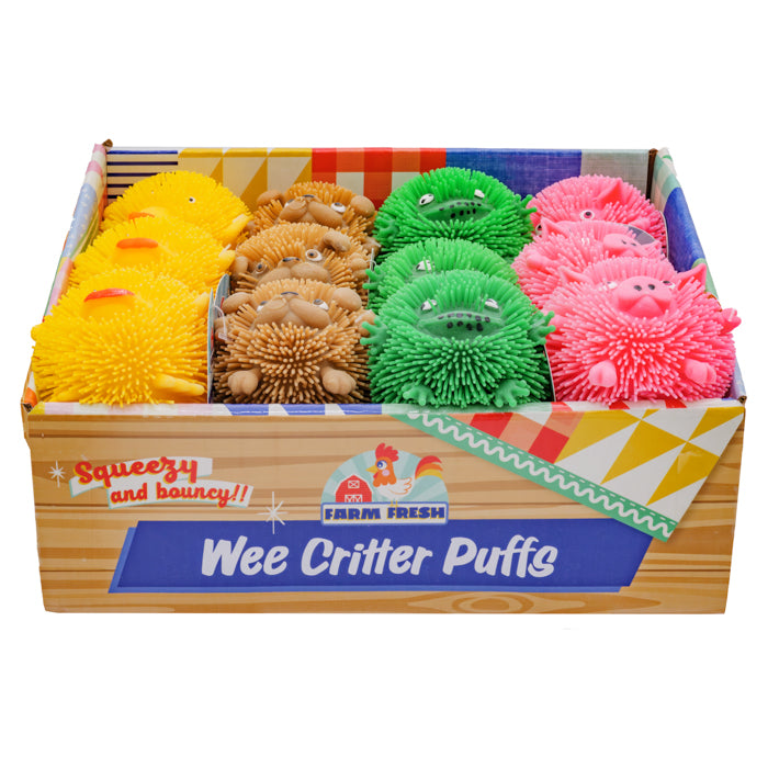 A Farm Fresh Wee Critter Puffs display box features squeezable, spiky animal sensory toys in yellow, brown, green, and pink with cute faces, arranged in rows.