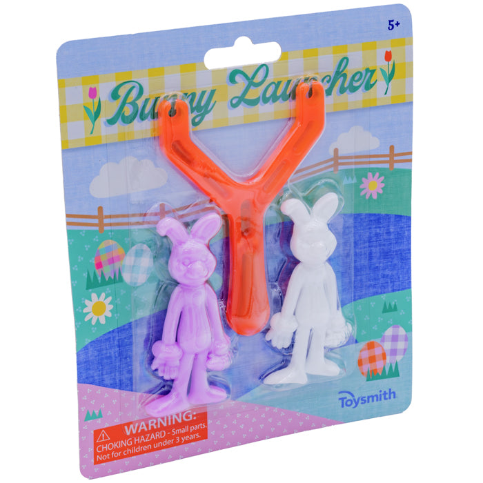The Toysmith Bunny Launcher set includes an orange slingshot and two bunny figures—one purple, one white—making it a fun Easter basket toy for spring play, all in festive Easter-themed packaging.