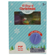 The Toysmith 12 Days of Christmas box is a festive toy advent calendar with 12 toy-filled capsules, visible through a window. A purple knob labeled "Twist. Twist. Pop!" adds fun. Warning: Small parts— not for kids under 3. Brand: Toysmith.