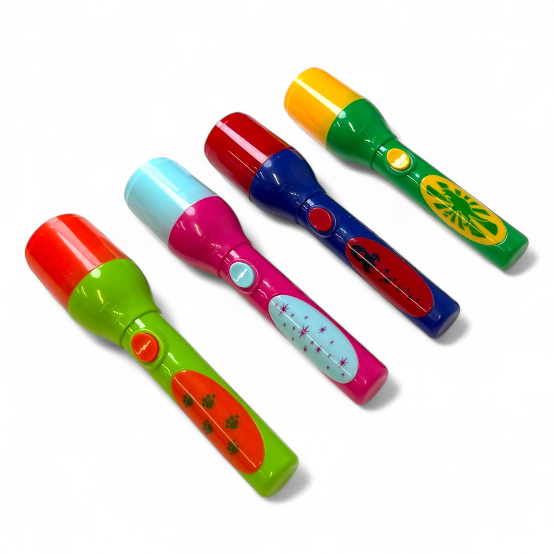 Four Toysmith Mini LED Flashlight Projectors, each with unique designs and bright colors, are arranged side by side on a white background. Each handheld Toysmith projector includes fun image disks for creative play.