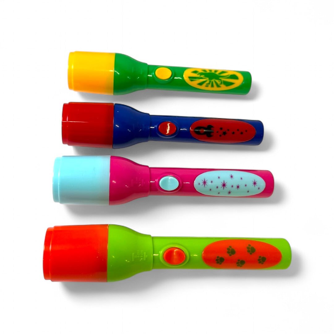 Four Toysmith Mini LED Flashlight Projectors by Toysmith, each with a unique color combo, are displayed on a white background. These mini projectors feature playful patterns like stars, ladybugs, and sunbursts.