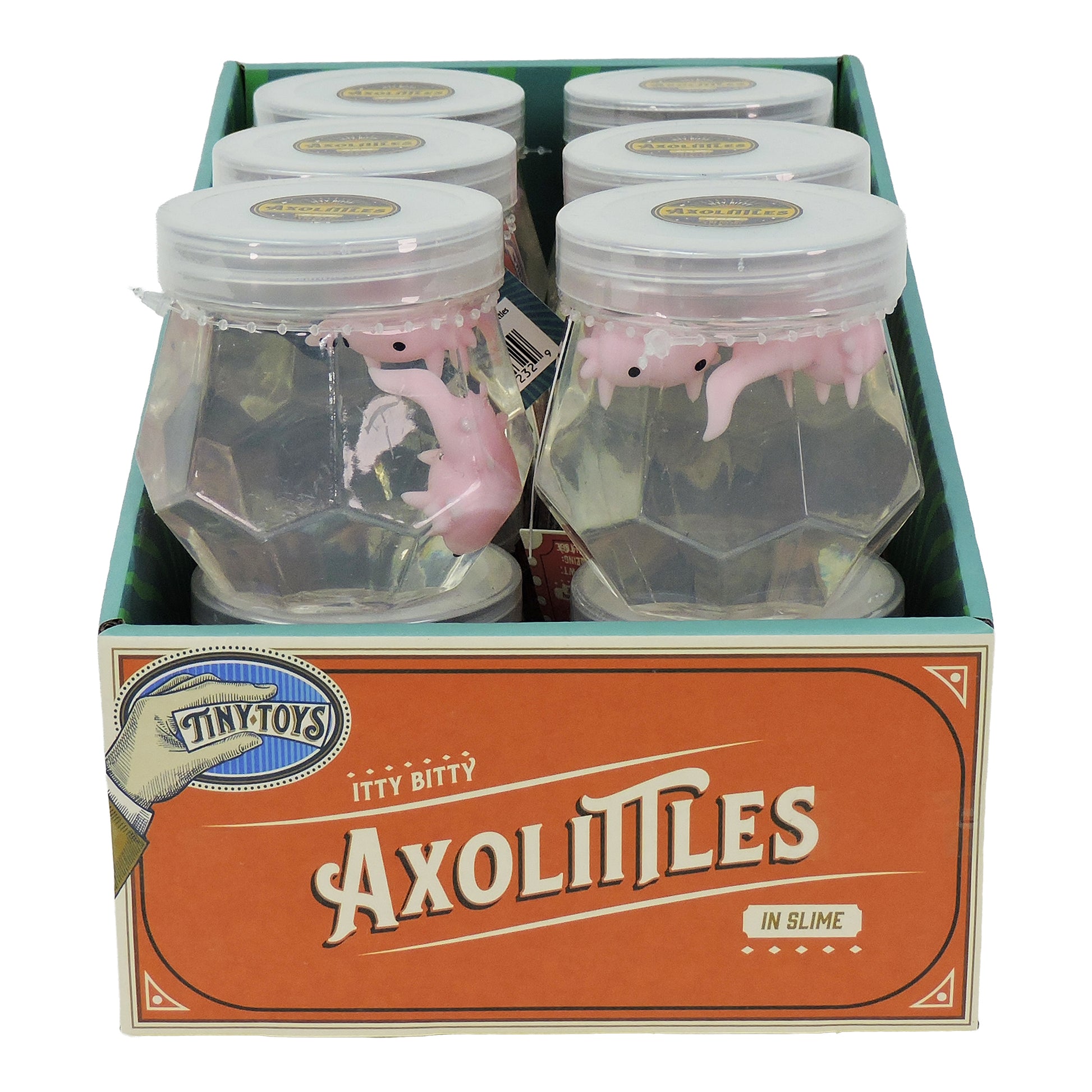 A display box labeled Tiny Toys Itty Bitty Axolittles contains six jars, each with a pink axolotl squishy toy in clear slime inside a faceted plastic container with a white lid for a fun sensory experience. Brand: Tiny Toys.