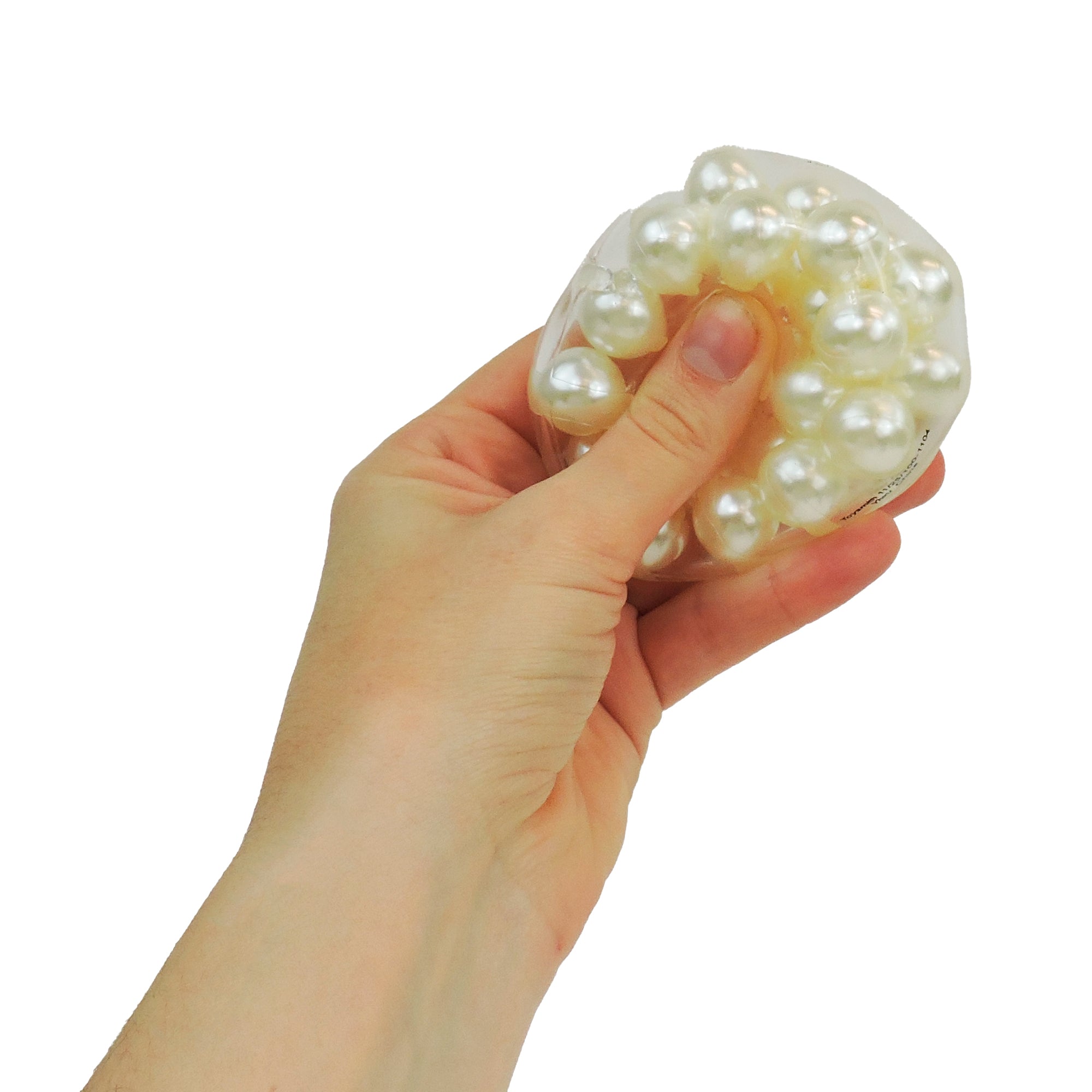 A person squeezes the Toysmith Clutchin' Pearls sensory ball by Toysmith, filled with white pearl beads, for stress relief against a white background.