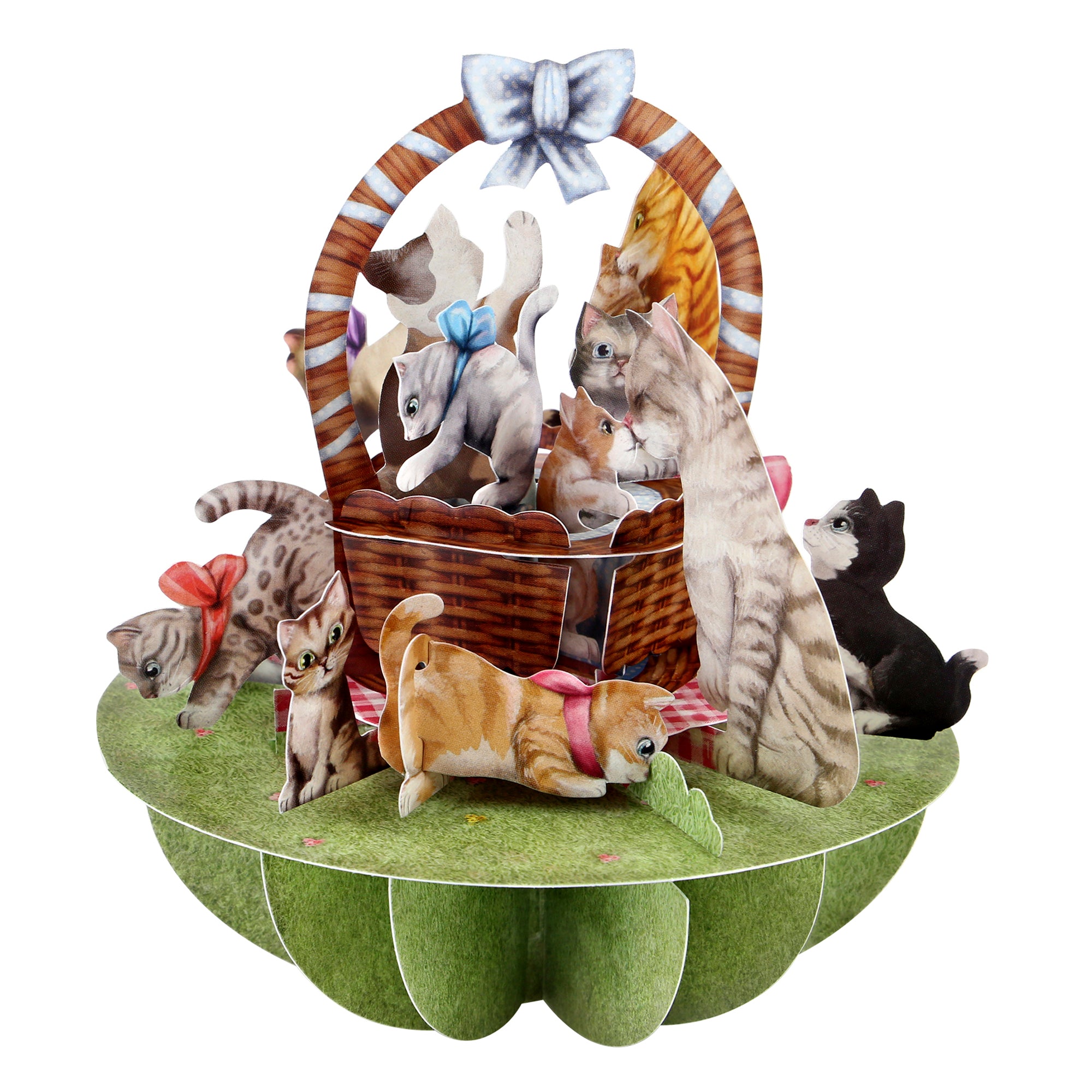 The Santoro Pirouette Card: Kittens in a Basket features playful cats with bows gathered around and inside a wicker basket with a blue ribbon, all set on a green flower-shaped base. The kittens interact playfully for a charming 3D pop-up effect.