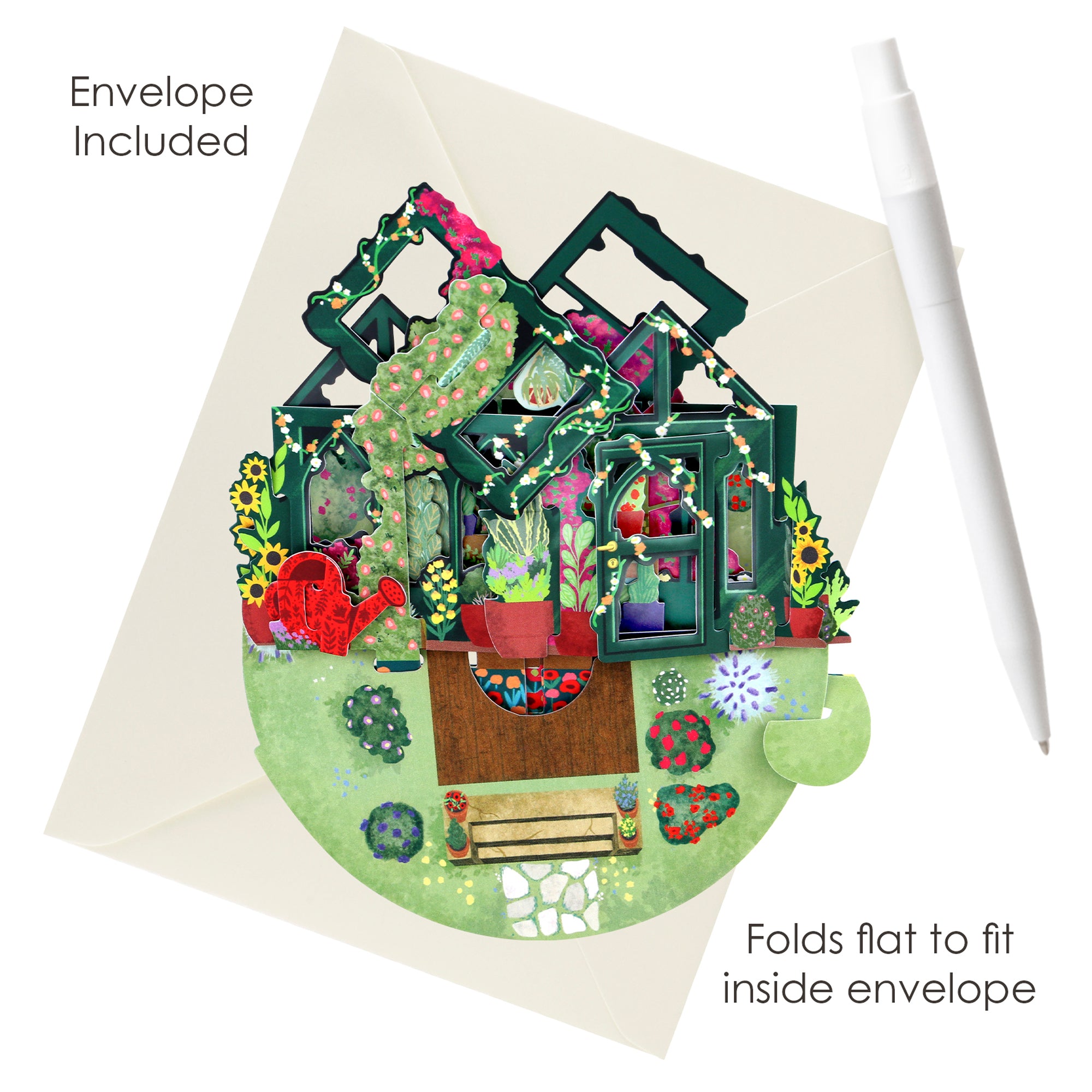 The Santoro Pirouette Card: Secret Garden, a vibrant pop-up greenhouse with plants and garden décor, sits on an open cream envelope labeled “Envelope Included” and “Folds flat to fit inside envelope,” with a white pen nearby.