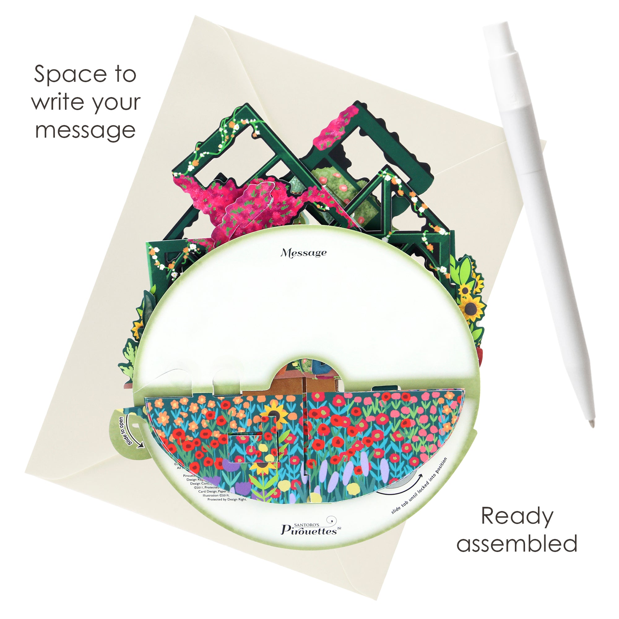 The Santoro Pirouette Card: Secret Garden features a vibrant garden scene, partially inserted into an envelope with a white pen beside it. Text states: Space to write your message and Ready assembled.
