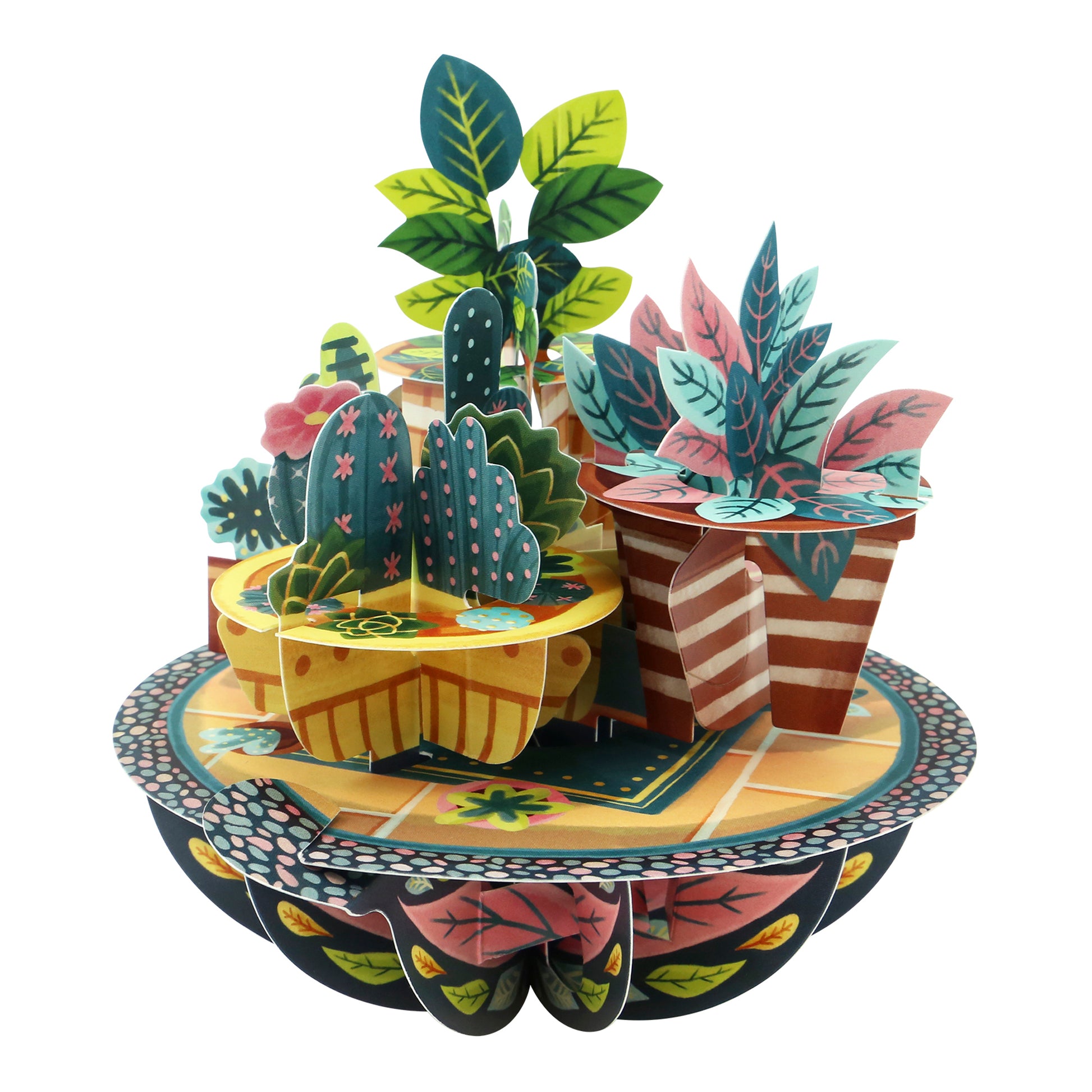 The Santoro Pirouette Card: Potted Plants is a vibrant 3D paper sculpture showcasing potted plants with green and pink leaves, cacti, and decorative pots arranged on a patterned circular base.