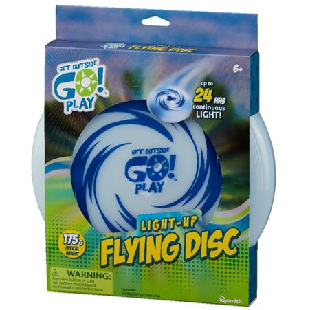 A blue and white box displays the GO! Play GO! Light-Up Flying Disc, featuring swirling graphics and text promoting up to 24 hours of continuous glow. The illuminated disc is visible through the partially open package.