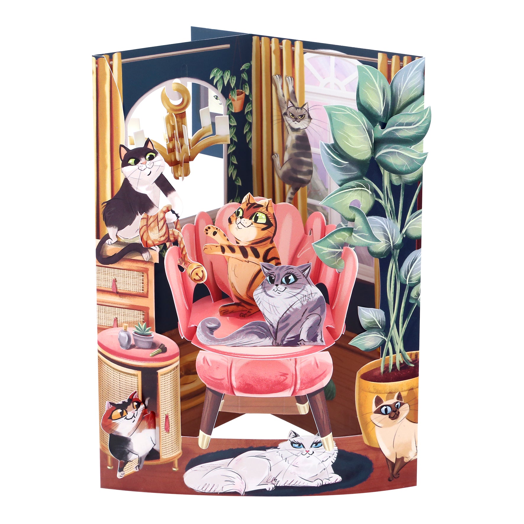 The Santoro Swing Card: Lounging Cats features six illustrated cats relaxing and playing in a vibrant, cozy room with colorful decor, large plants, and a pink chair. Some cats sit, stretch, or climb amid the cheerful setting.