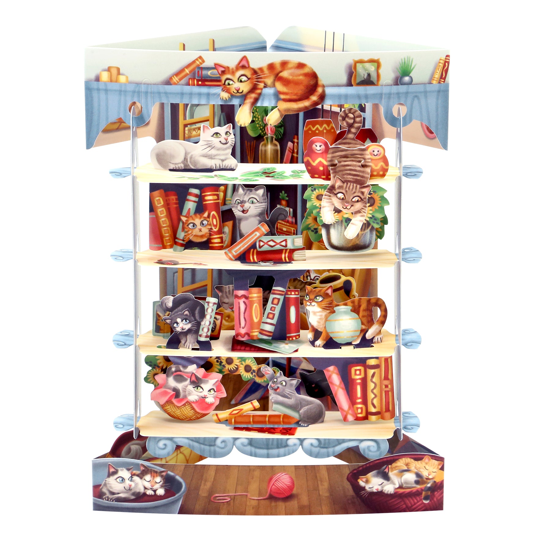 The Santoro Swing Card: Cats in the Library features playful cats lounging, climbing shelves, and interacting with books and yarn balls in a charming bookshelf scene.