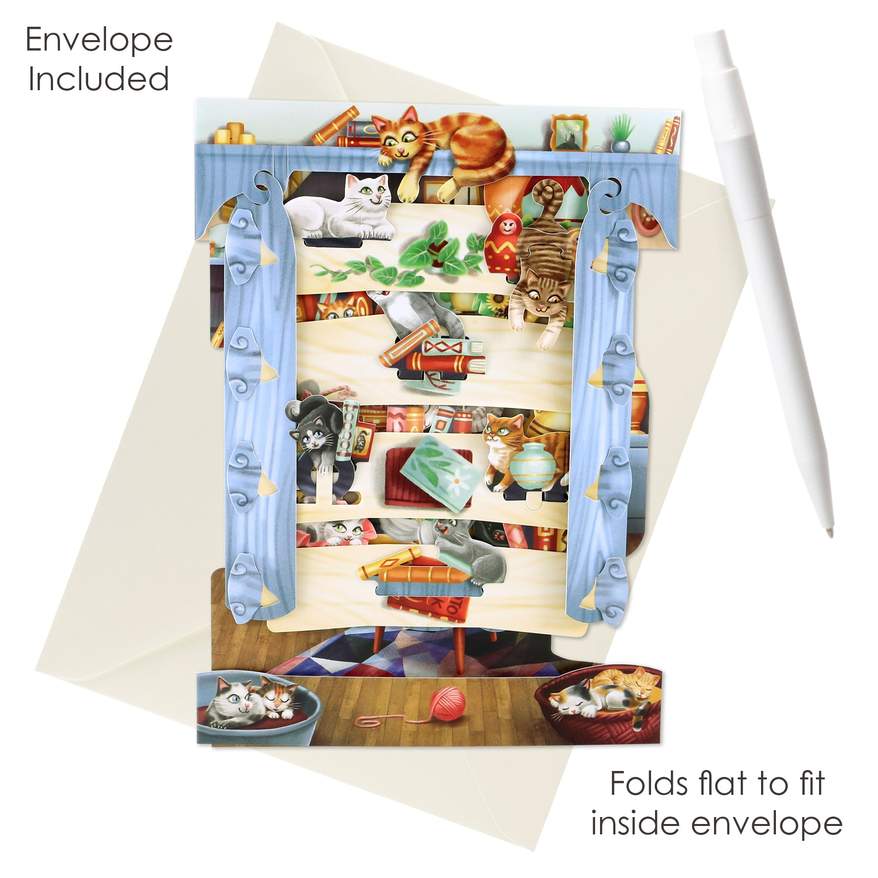 The Santoro Swing Card: Cats in the Library is a 3D pop-up greeting card with playful cats on library shelves. It stands upright, folds flat to fit inside the included envelope, and is shown next to a white pen.