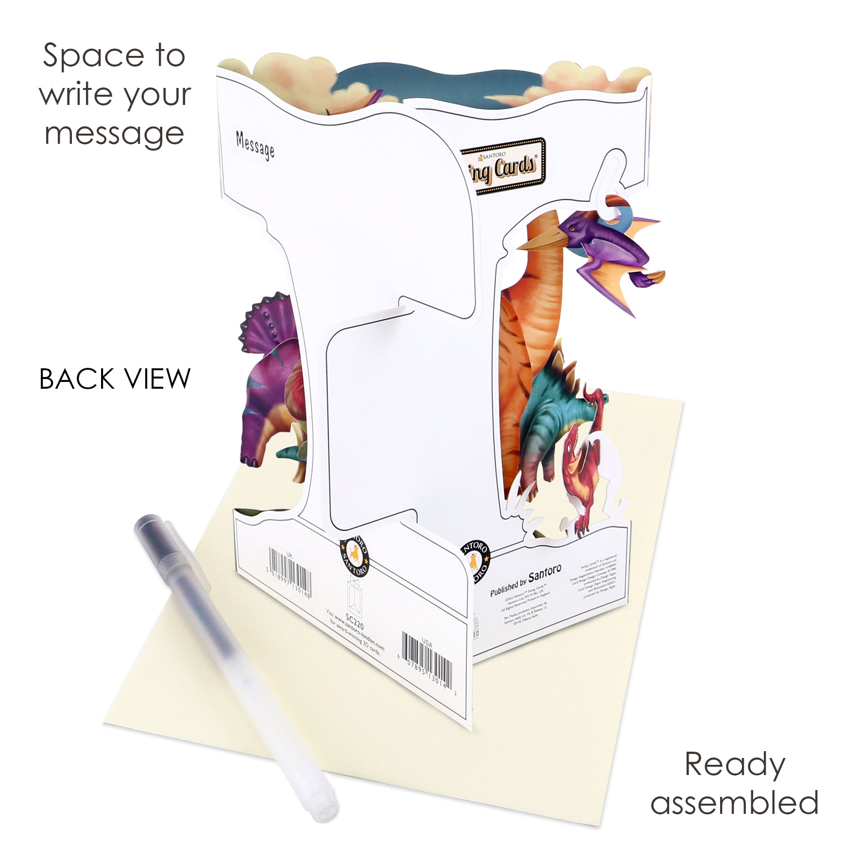 The Santoro Swing Card: Land of the Dinosaurs is a 3D pop-up card shown from the back, standing upright next to a pen and an envelope. Labeled areas show where to write your message, and it comes fully assembled.