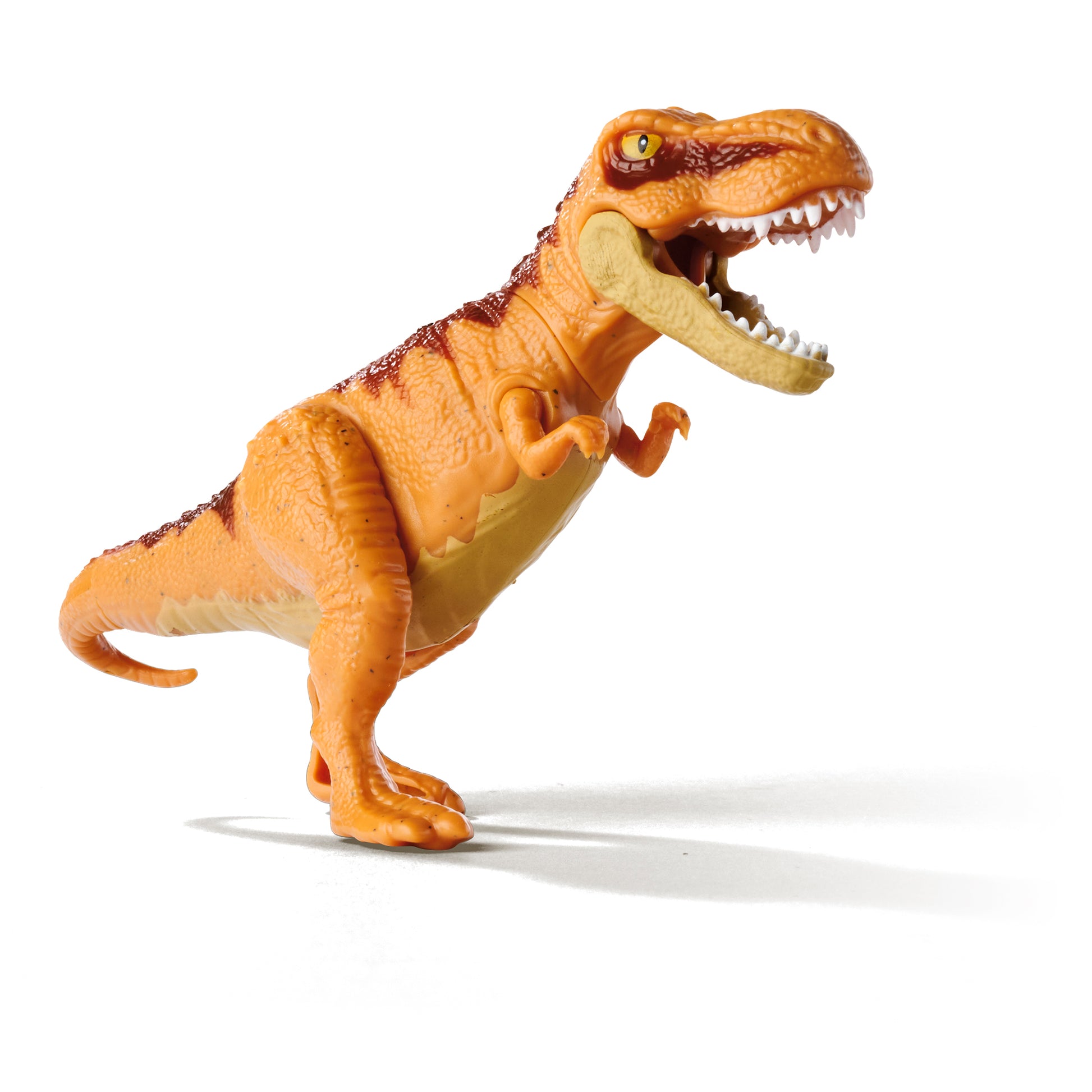 The Simba Dickie Light & Sound Dino Egg Asst features an orange T. rex toy with dark stripes, standing on two legs with its mouth open to show its teeth. Light and sound effects add excitement to any collection. White background shown.