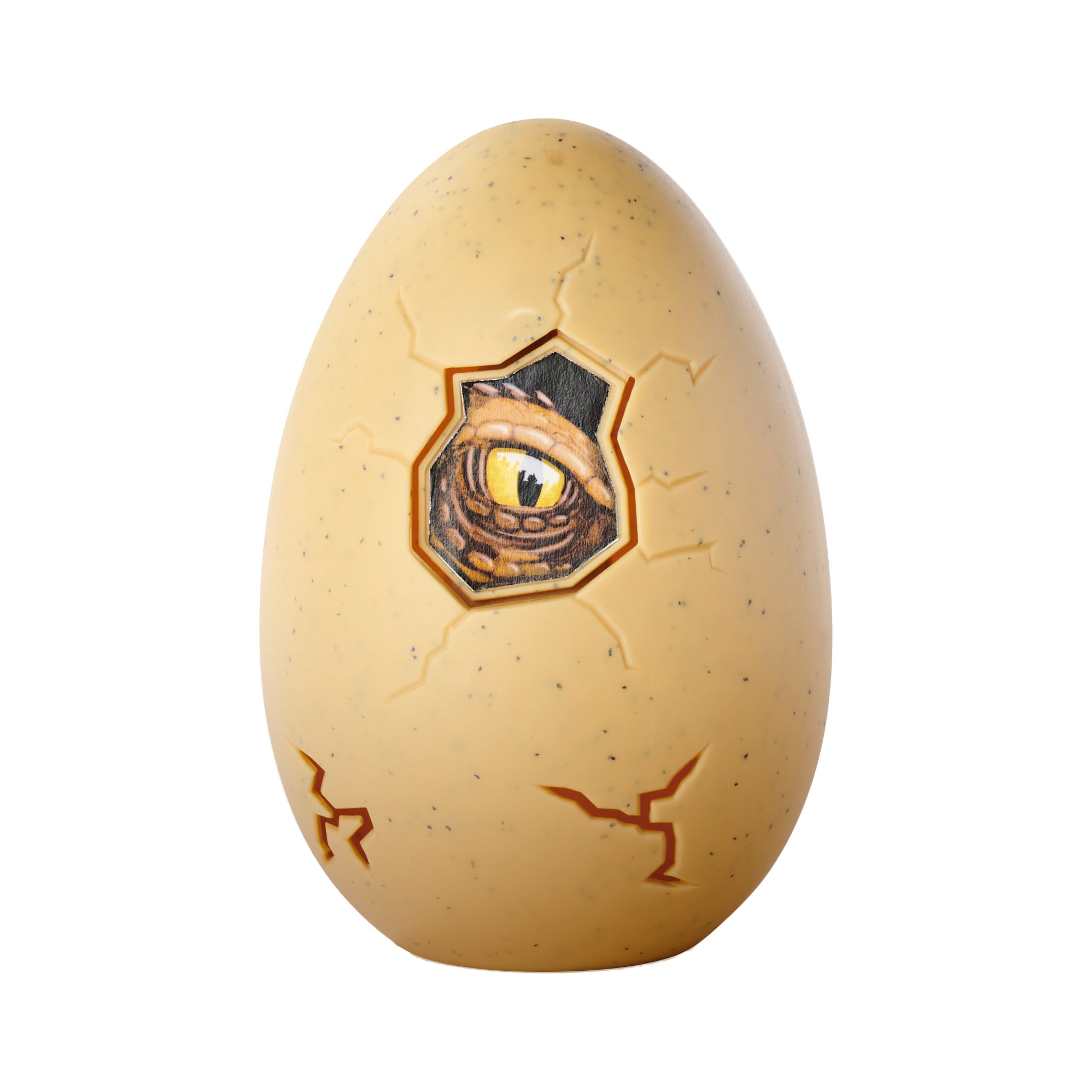 The Simba Dickie Light & Sound Dino Egg Asst is a beige, speckled dinosaur egg toy with cracks and a hole revealing a reptilian yellow eye. It features exciting light and sound effects for added fun.