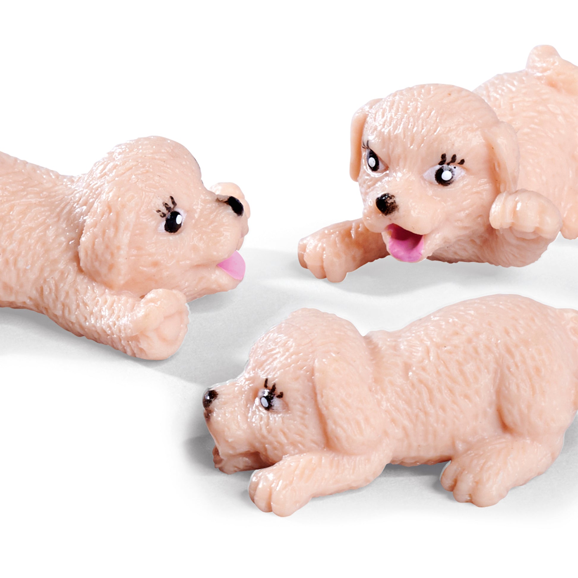 Three small, light brown plush puppies with textured fur, black noses, and cartoon eyes lie playfully on a white background—ideal companions for the Simba Dickie EL Puppy Doctor playset.