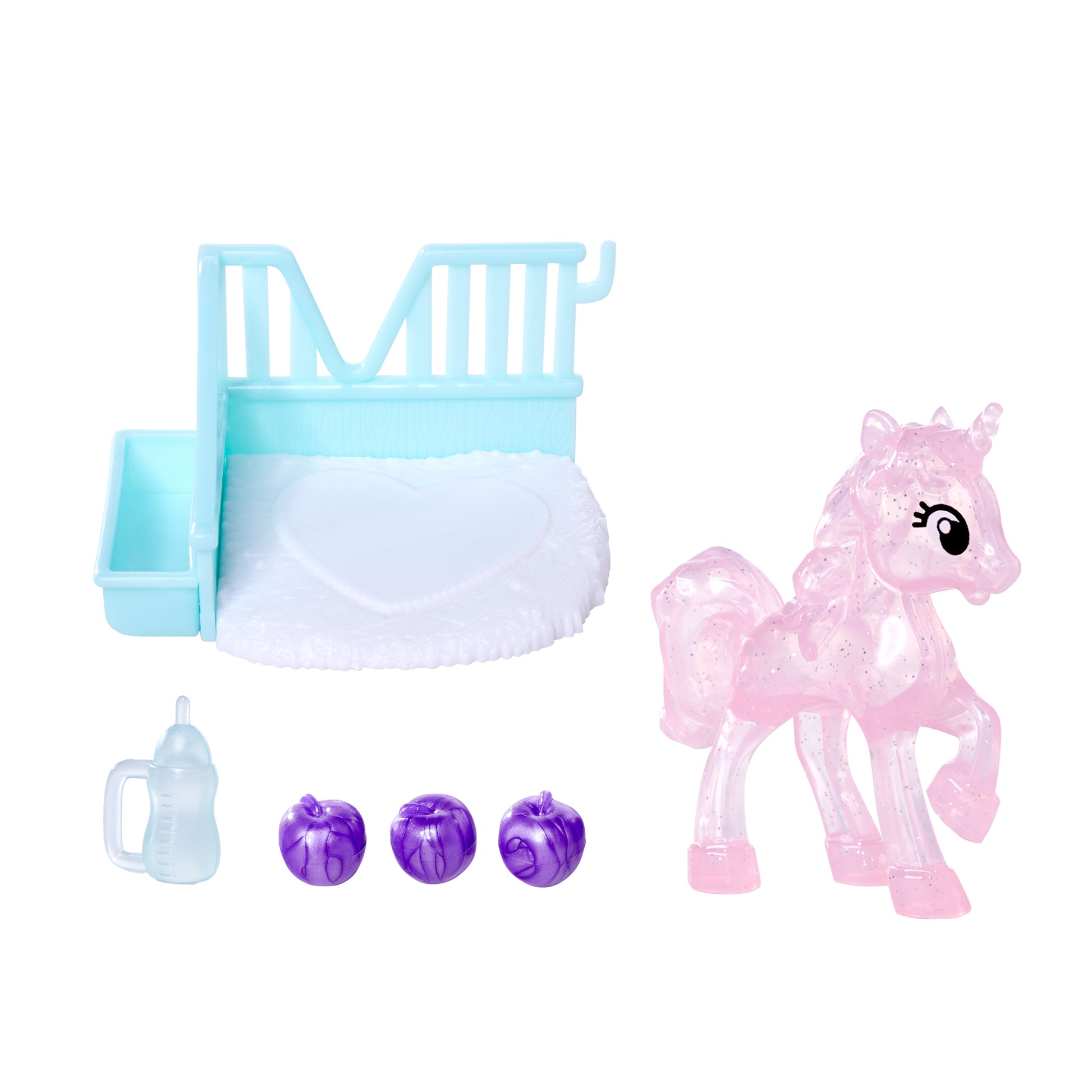 A translucent pink unicorn from the Simba Dickie EL Unicorn set, a blue and white toy bed with heart bedding, a doll baby bottle, and three small purple toy apples are arranged on a white background.