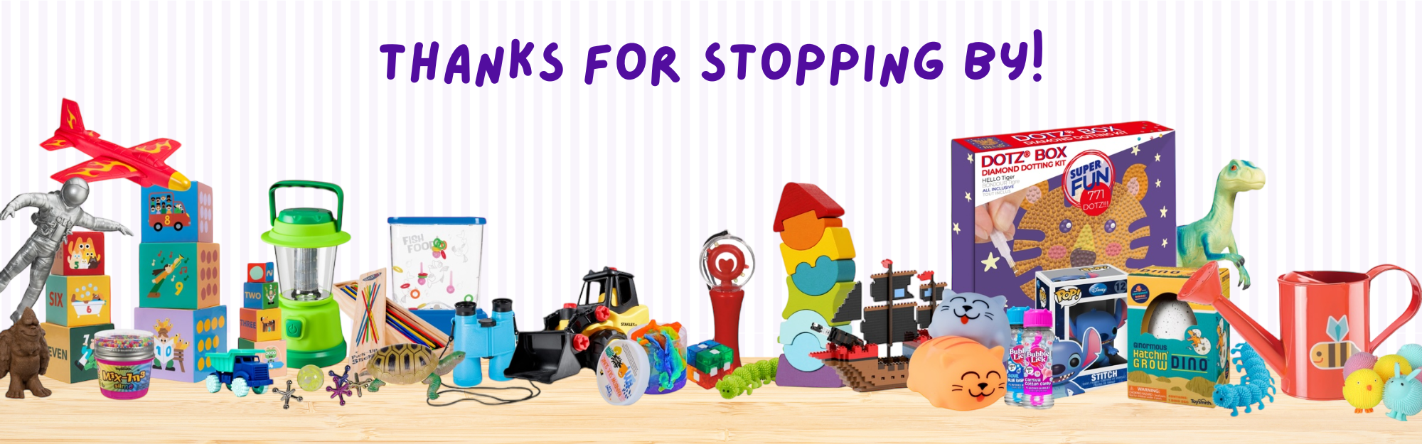 A colorful display of various toys and playsets, including dinosaurs, a red toy airplane, building blocks, art supplies, and a watering can, with the text “THANKS FOR STOPPING BY!” above them.