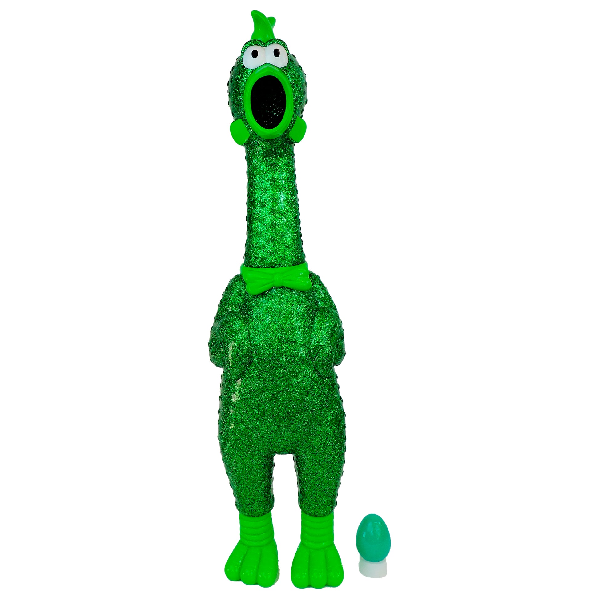 Say Whaaaaat?! The Ampli-Flyer by Say Whaaaaat! features a green rubber chicken toy with wide eyes, textured surface, and a bowtie standing upright beside a small green and white egg on a white background.