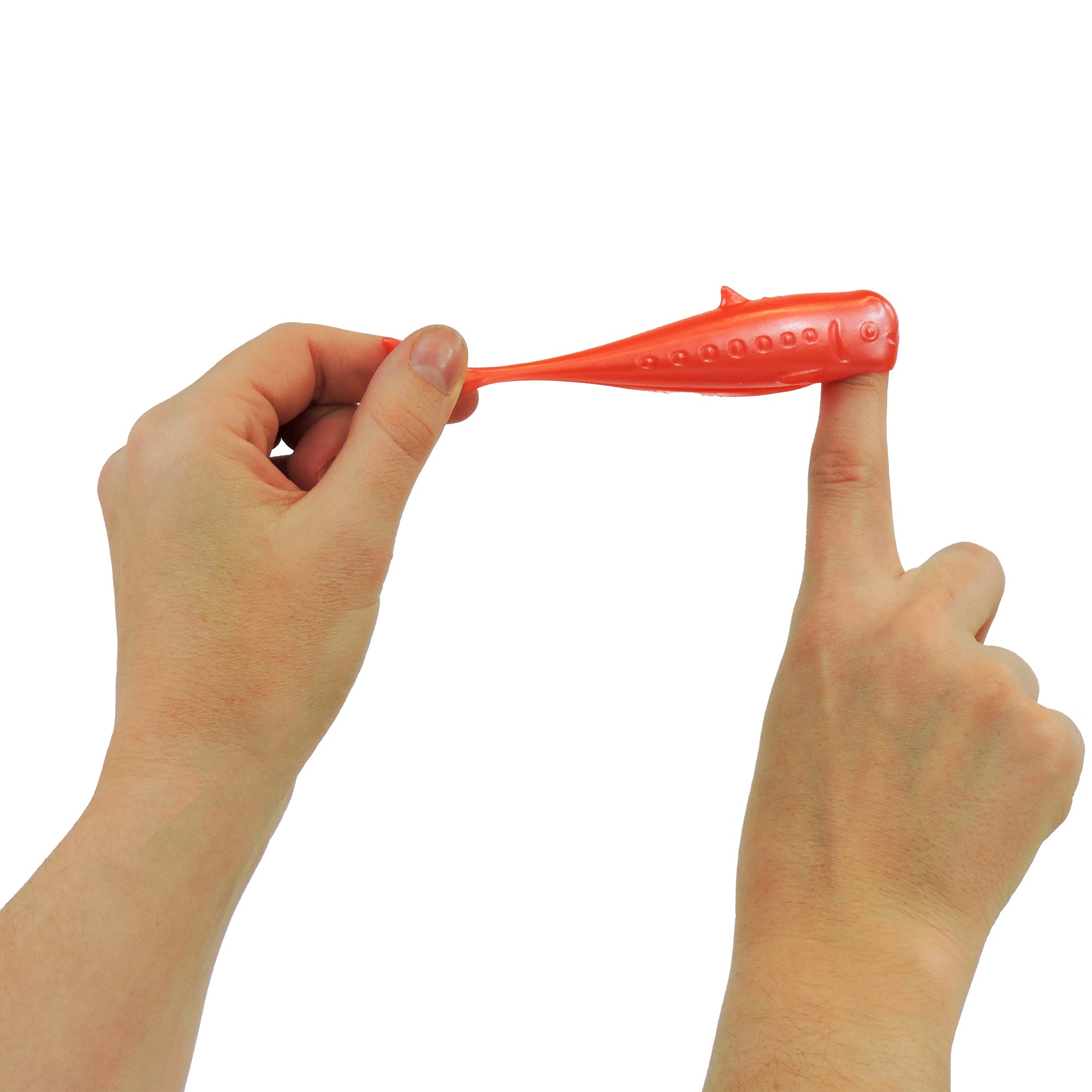 A person stretches a pink Toysmith Tinned Fish Flingers toy between their thumb and index finger against a white background.
