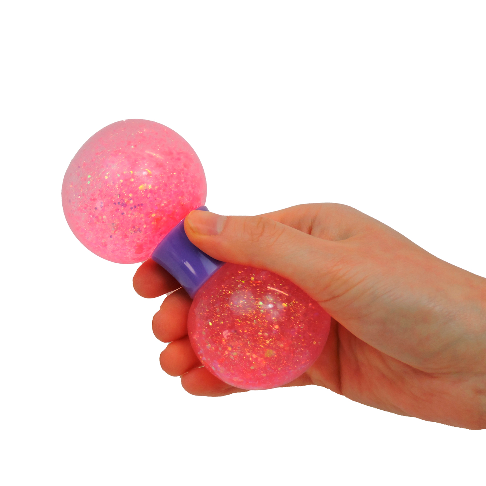 A hand holds the Sensory Lab Squeez-E Swirls, a pink glittery stress ball toy with two round ends and a purple connector, set against a white background.