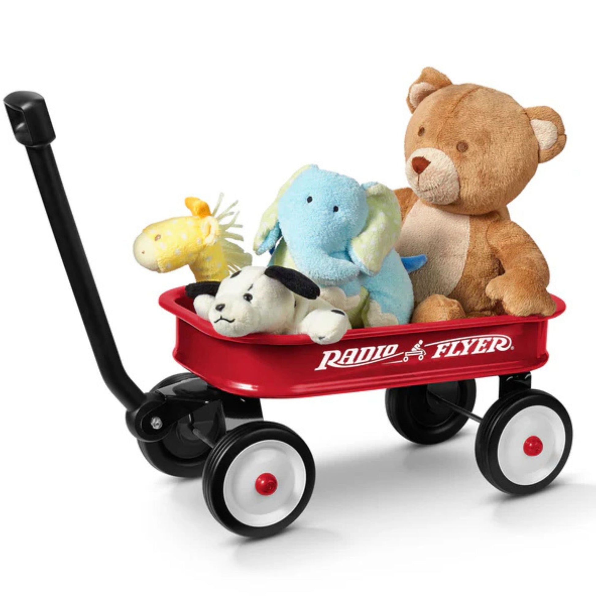 A Radio Flyer Little Red Toy Wagon by Radio Flyer is filled with stuffed animals—a brown teddy bear, blue elephant, yellow giraffe, and white dog—sparking imaginative play against a plain white background.