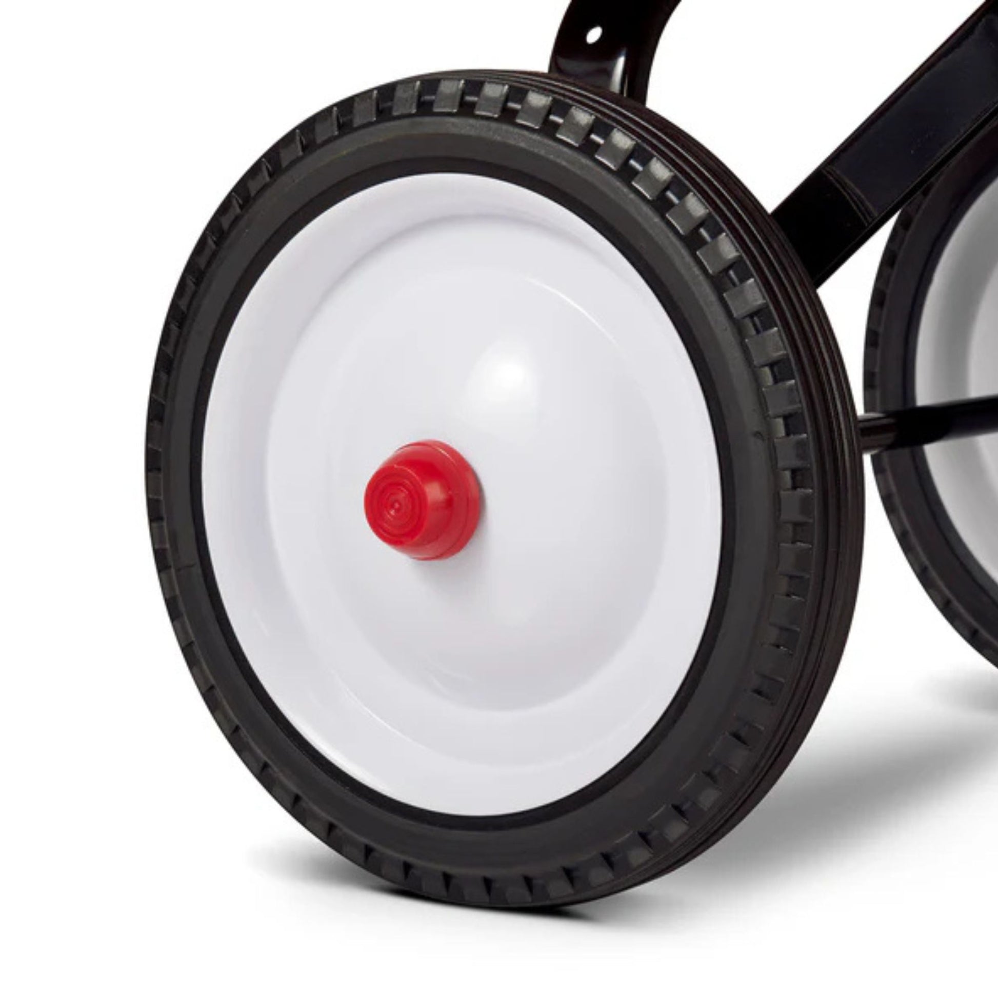 Close-up of a black plastic wheel with a white center and red hubcap, attached to the Radio Flyer Little Red Toy Wagon by Radio Flyer. Features include a textured grip rim and durable black metal frame, ideal for imaginative play.