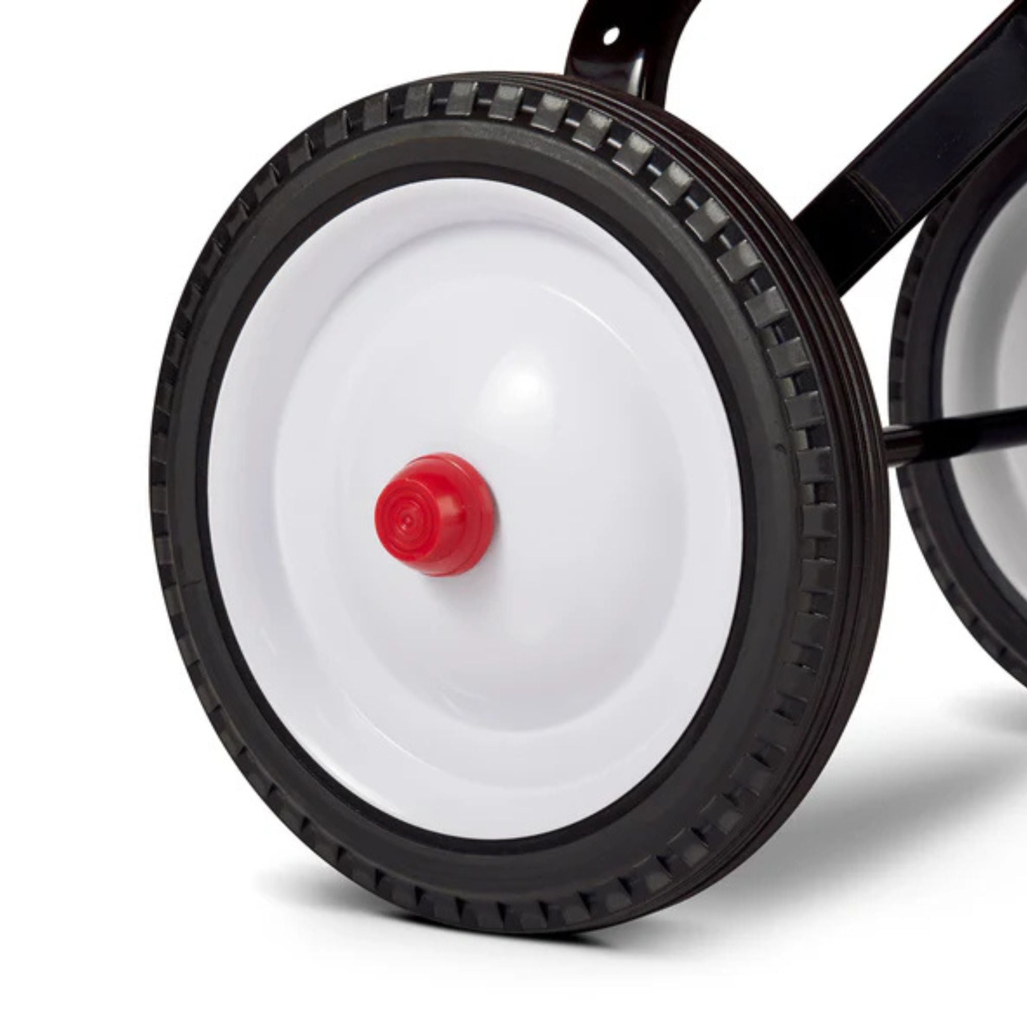 Close-up of a black plastic wheel with a white center and red hubcap, attached to the Radio Flyer Little Red Toy Wagon by Radio Flyer. Features include a textured grip rim and durable black metal frame, ideal for imaginative play.