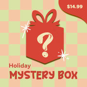 A red gift box with a question mark and sparkles sits on a green and peach checkered background. Text reads “Holiday Stocking Stuffer Box” and “$14.99”—perfect for filling stockings with mystery holiday goodies.