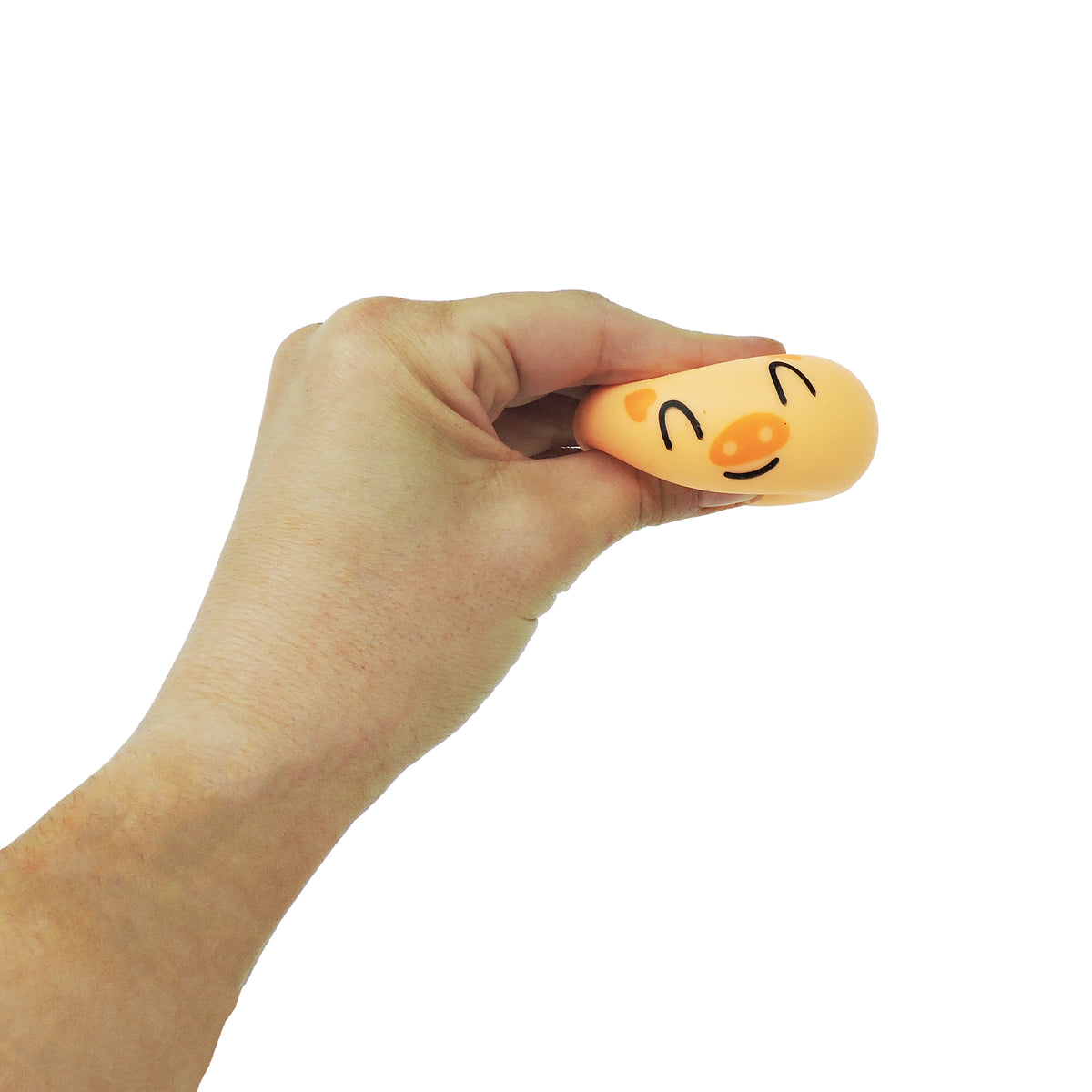 A hand squeezes a small, orange stress ball with a smiling face, set against a white background—ideal for fans of Toysmith Bao Bun Buddies and cute animal-themed squishies from Toysmith.