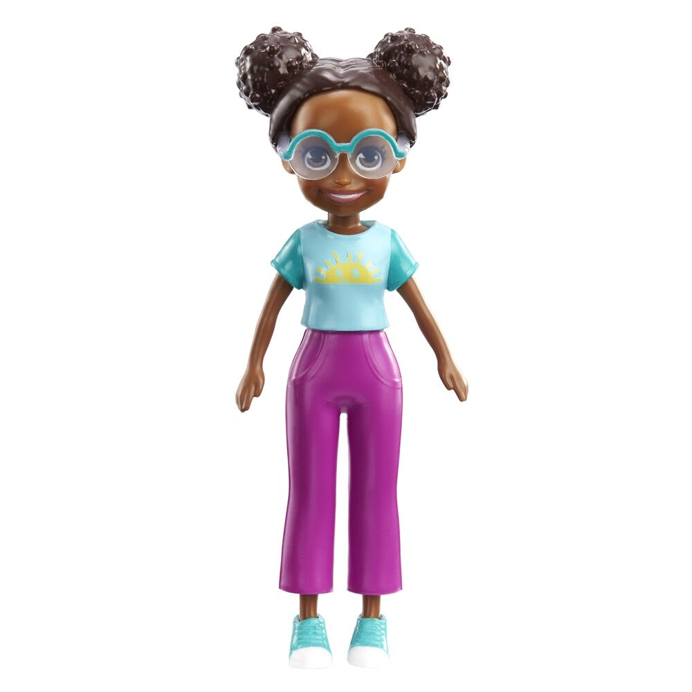 The Mattel Small Polly Pocket Doll features dark skin, curly hair in two buns, big blue glasses, a light blue sun-print shirt, bright pink pants, and blue shoes—ideal for imaginative play.