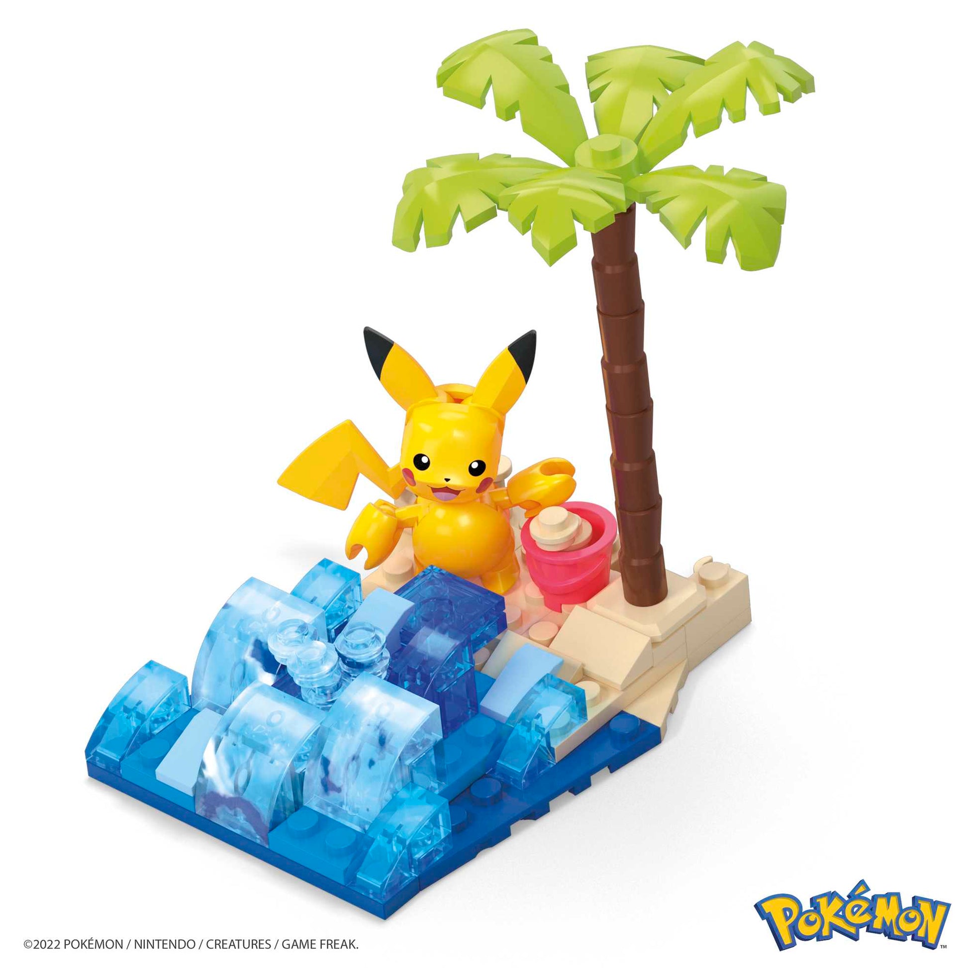 A MEGA Pokemon Pikachu's Beach Splash figure by Mega Bloks sits on a sandy beach with a palm tree, blue LEGO-style waves, pink bucket, and seashell—ideal for fans of Adventure Builder sets or Pokémon building toys. Pokémon logo at bottom right.