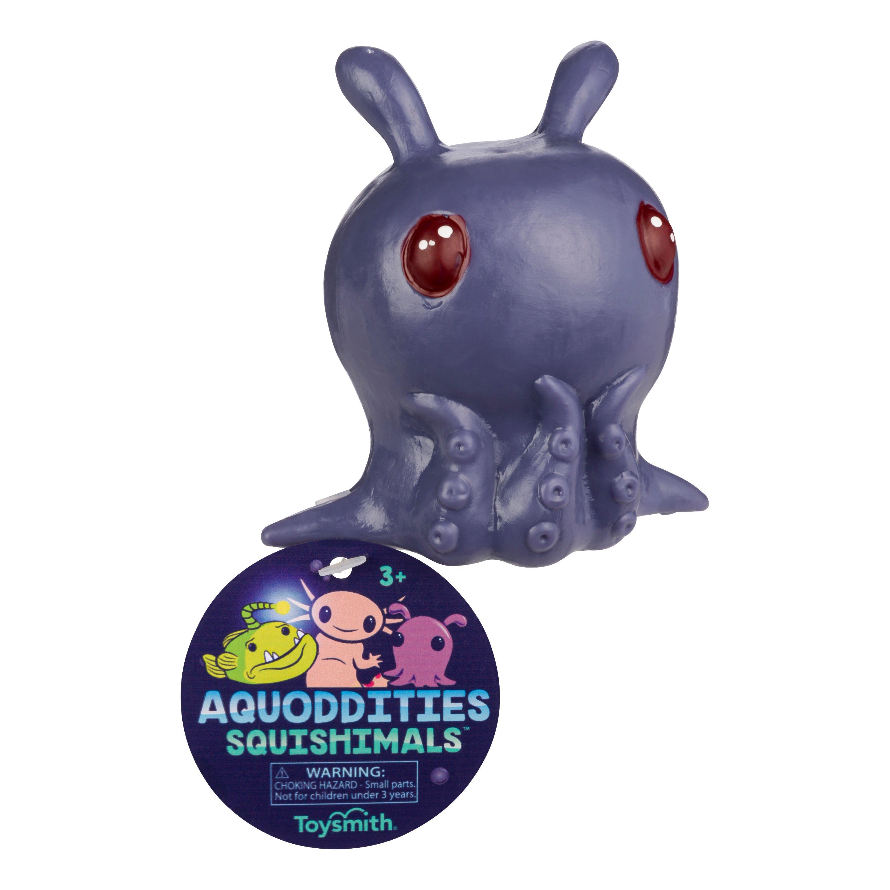 A purple, octopus-like Toysmith Aquoddities Squishimals fidget toy with big red eyes sits above a round tag featuring cartoon sea creatures and a warning for ages 3+, from the brand Toysmith.