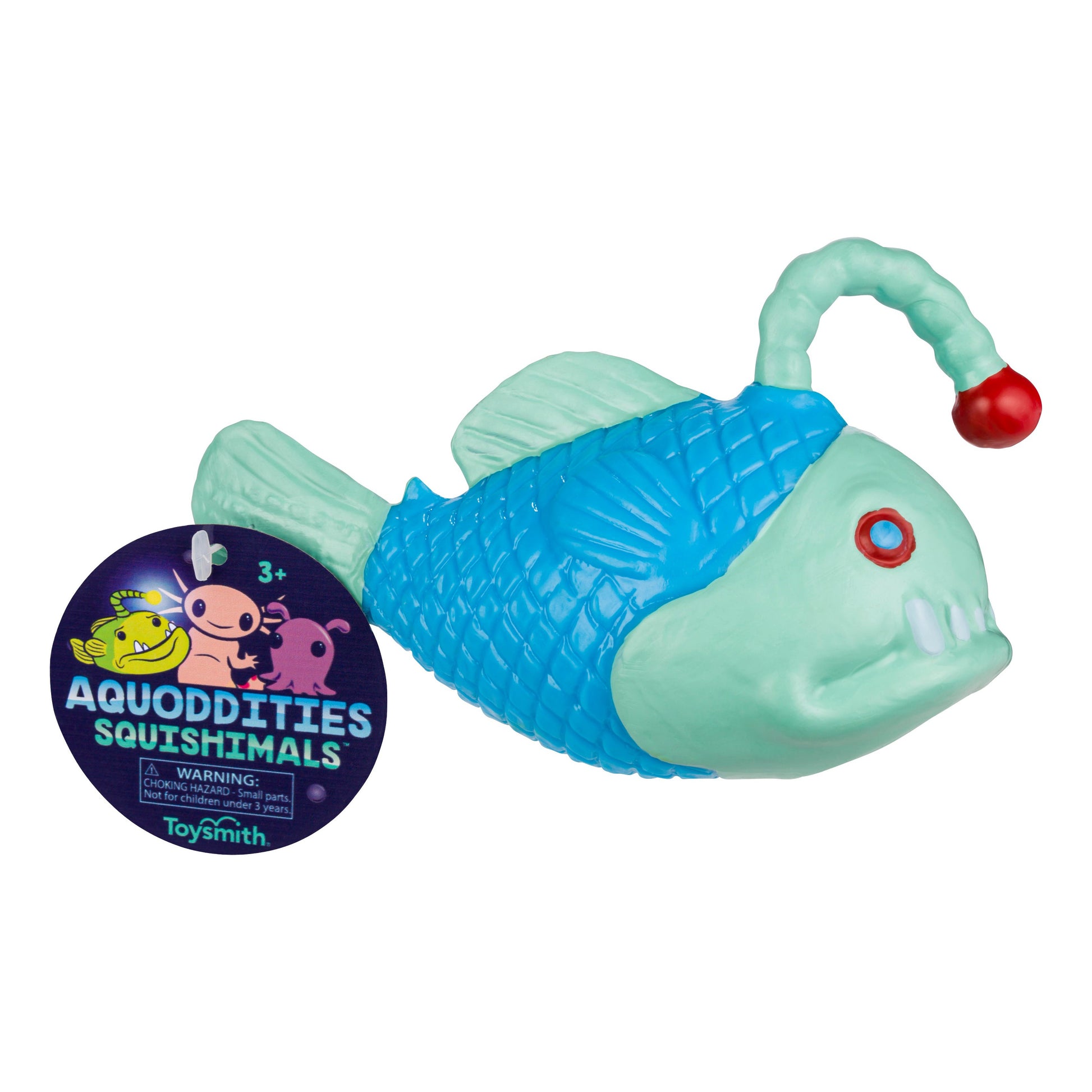 A light blue and aqua anglerfish-shaped Toysmith Aquoddities Squishimals squishy toy with a red lure sits next to a round tag featuring the Toysmith brand name, product name, and cartoon sea creatures.