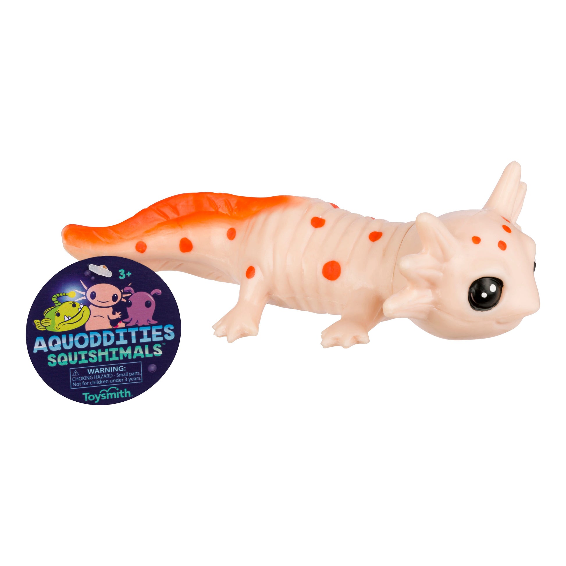 A soft, squishy toy axolotl with orange spots and a bright tail sits beside a round Toysmith Aquoddities Squishimals label featuring cute sea creatures—ideal for aquatic-themed squishy and fidget toy fans.